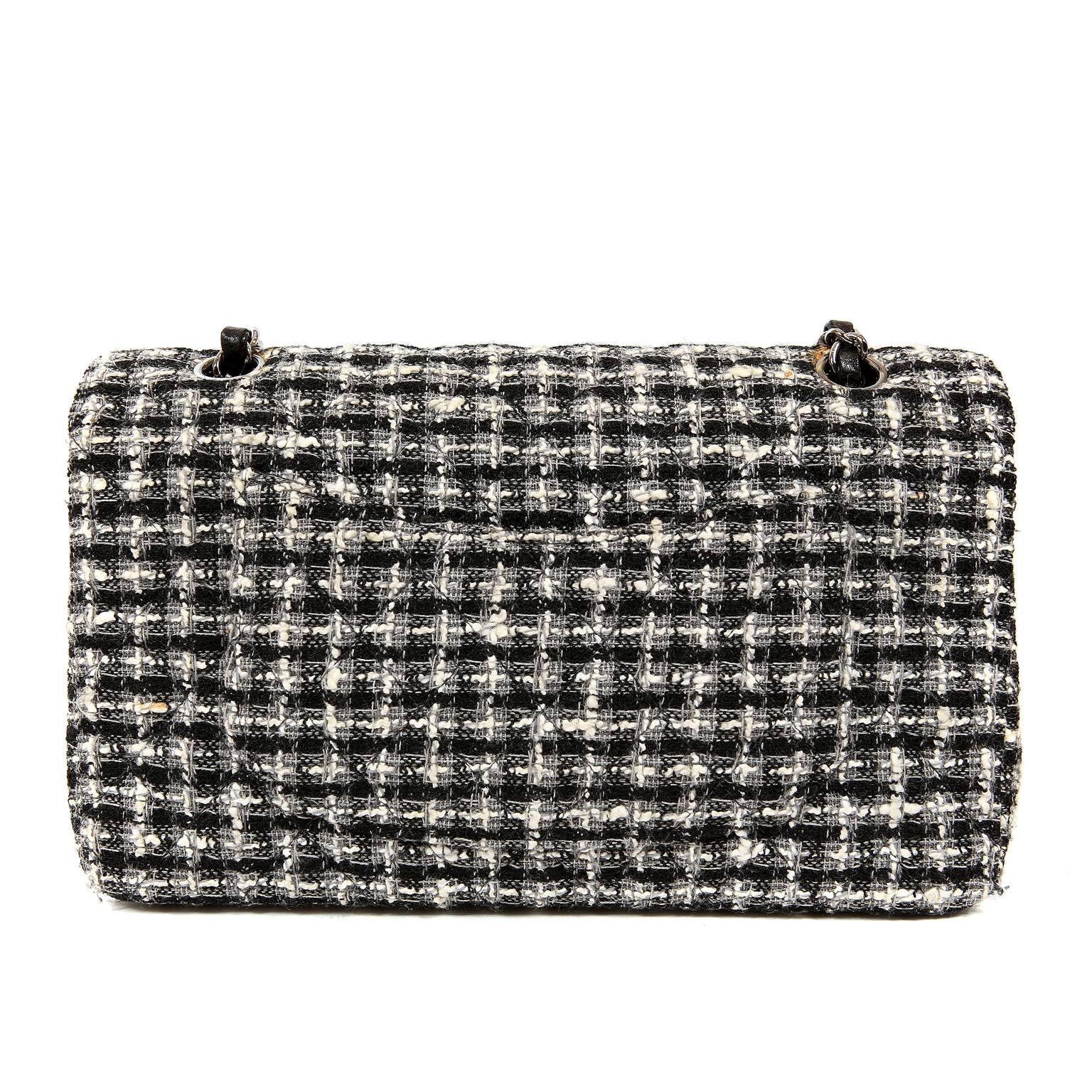 Chanel Black and White Tweed  Double Flap Classic Bag-  EXCELLENT
  The tweed boucle combines beautifully with the signature Chanel quilted pattern.  It is a true classic, in every sense of the word.   
Black and winter white tweed boucle fabric is