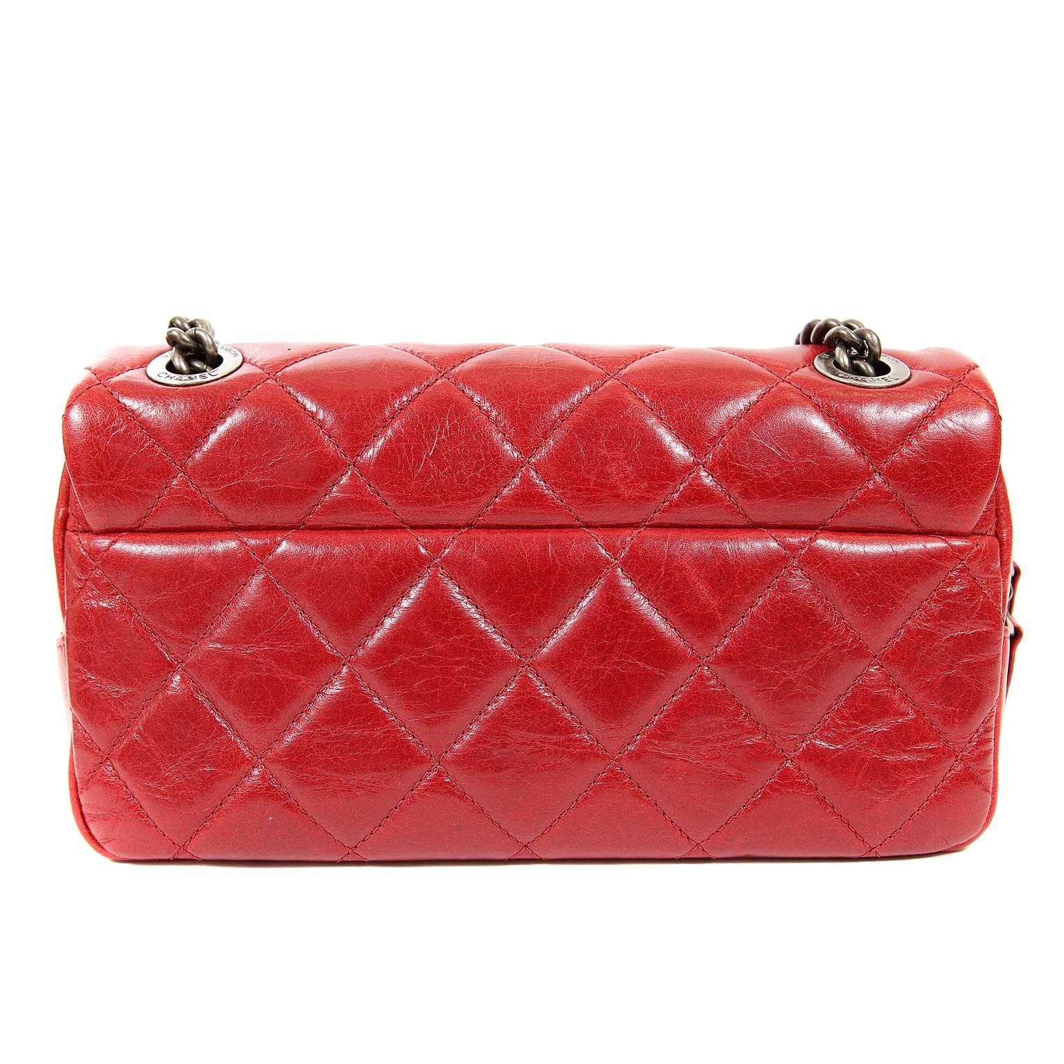 Chanel Red Distressed Leather Crossbody Bag- PRISTINE; appears never carried
  Uniquely designed with a strap that may be worn single or double, this small flap bag is extremely versatile.  
Lipstick red leather is intentionally distressed with a