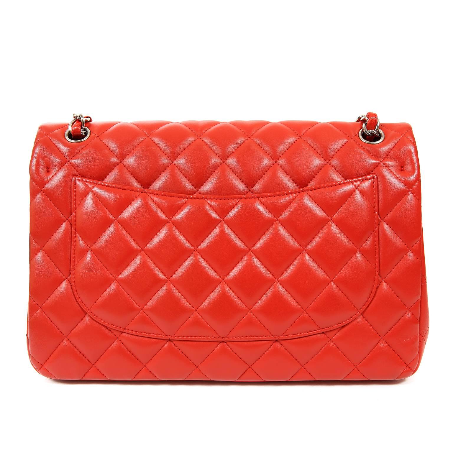 Chanel Red Lambskin Jumbo Classic Double Flap Bag- PRISTINE.  Never Before Carried. 
The highly sought-after Jumbo Classic is exquisite in lipstick red lambskin with silver hardware.  
Vibrant red lambskin is quilted in signature Chanel diamond