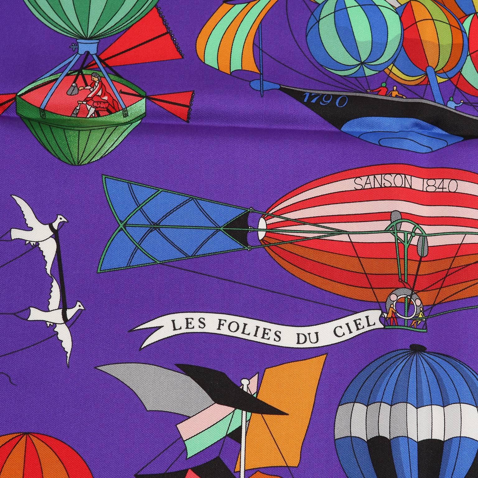 Hermès Purple Les Folies du Ciel 90 cm Silk Scarf- New with box
Designed by Loic Dubigeon, the print features multicolored hot air balloons on a royalty worthy purple background.  100% silk.  Made in France. 
A195
