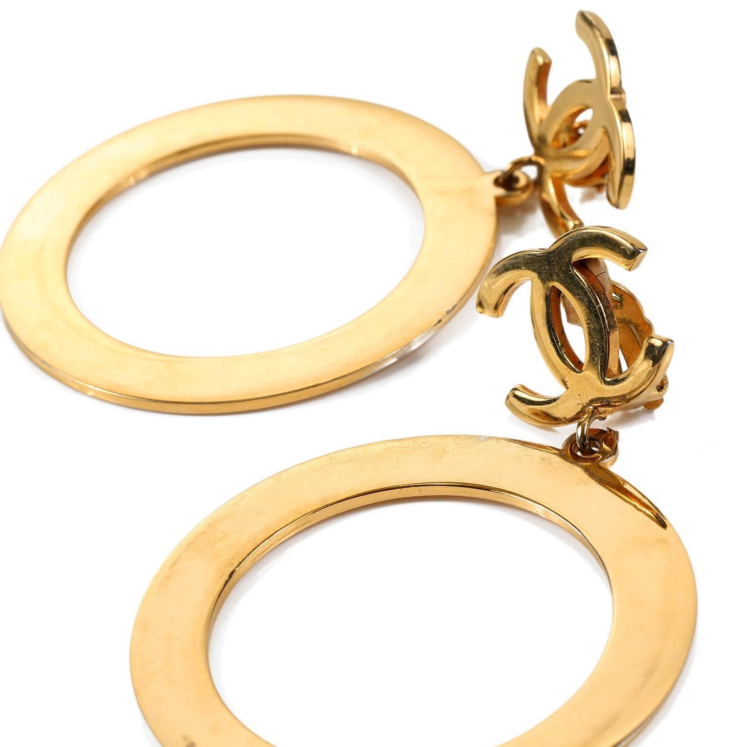 These authentic Chanel Gold CC Hoop Earrings are in mint condition.  
Large round gold hoops dangle from CC interlocking CC’s.  Clip on style.
A219