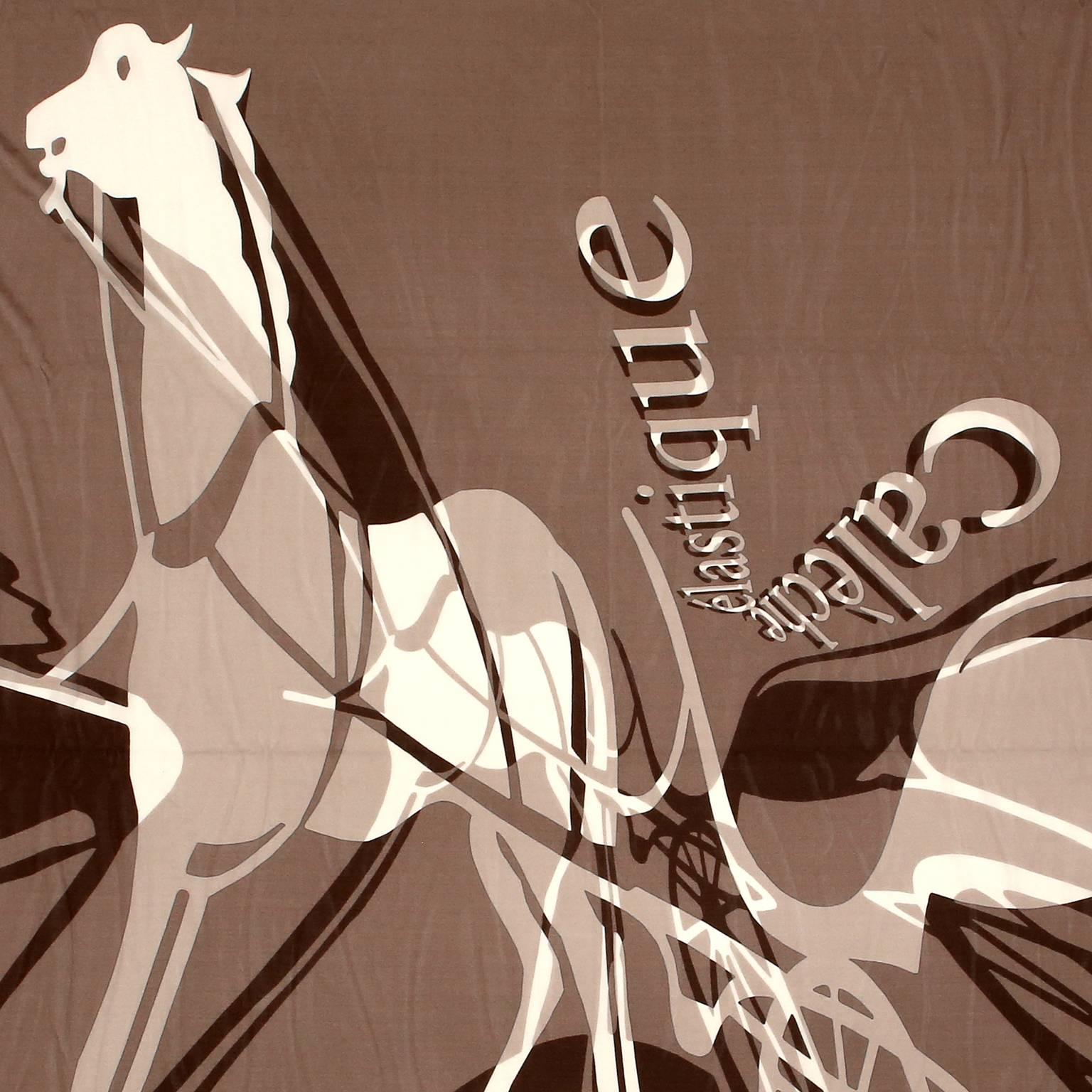 This authentic Hermès Caleche Elastique 90 cm Silk Scarf is pristine.  Designed by Bali Barret, this “elastic carriage” design features the iconic Hermès horse and groom in a neutral brown colorway.  Stretched and distorted in an abstract fashion,