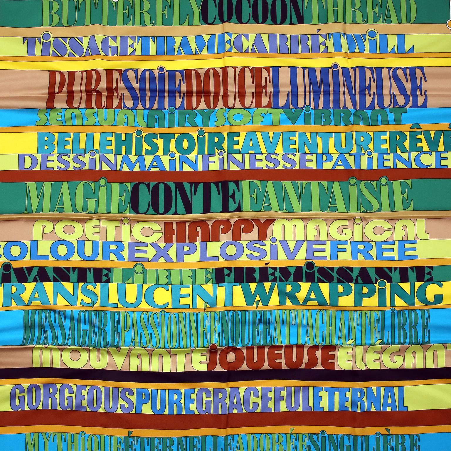 This authentic Hermès Mots de Soie 90 cm Silk Scarf is new.  Designed by Virginie Jamin and released in 2011.  Chartreuse border with colorful stacks of words describing silk in various languages, fonts and sizes.  Made in France.  100% silk.