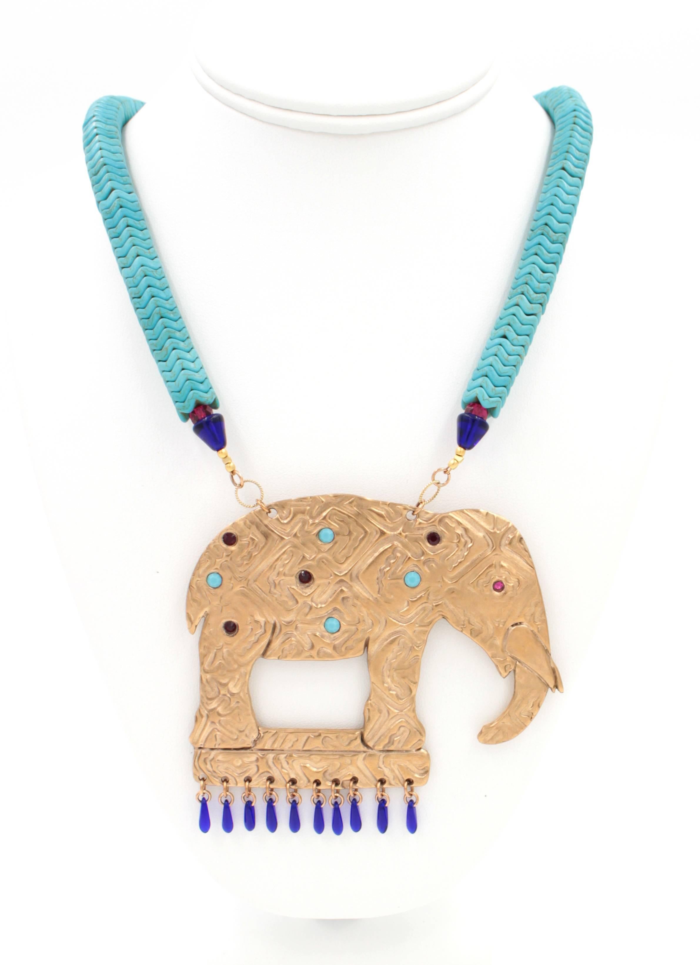 The Elephant Necklace features a stunning array of red and vintage turquoise Swarovski Crystals set in Bronze with cobalt blue glass bead fringe. The necklace is made of brilliant turquoise beads.