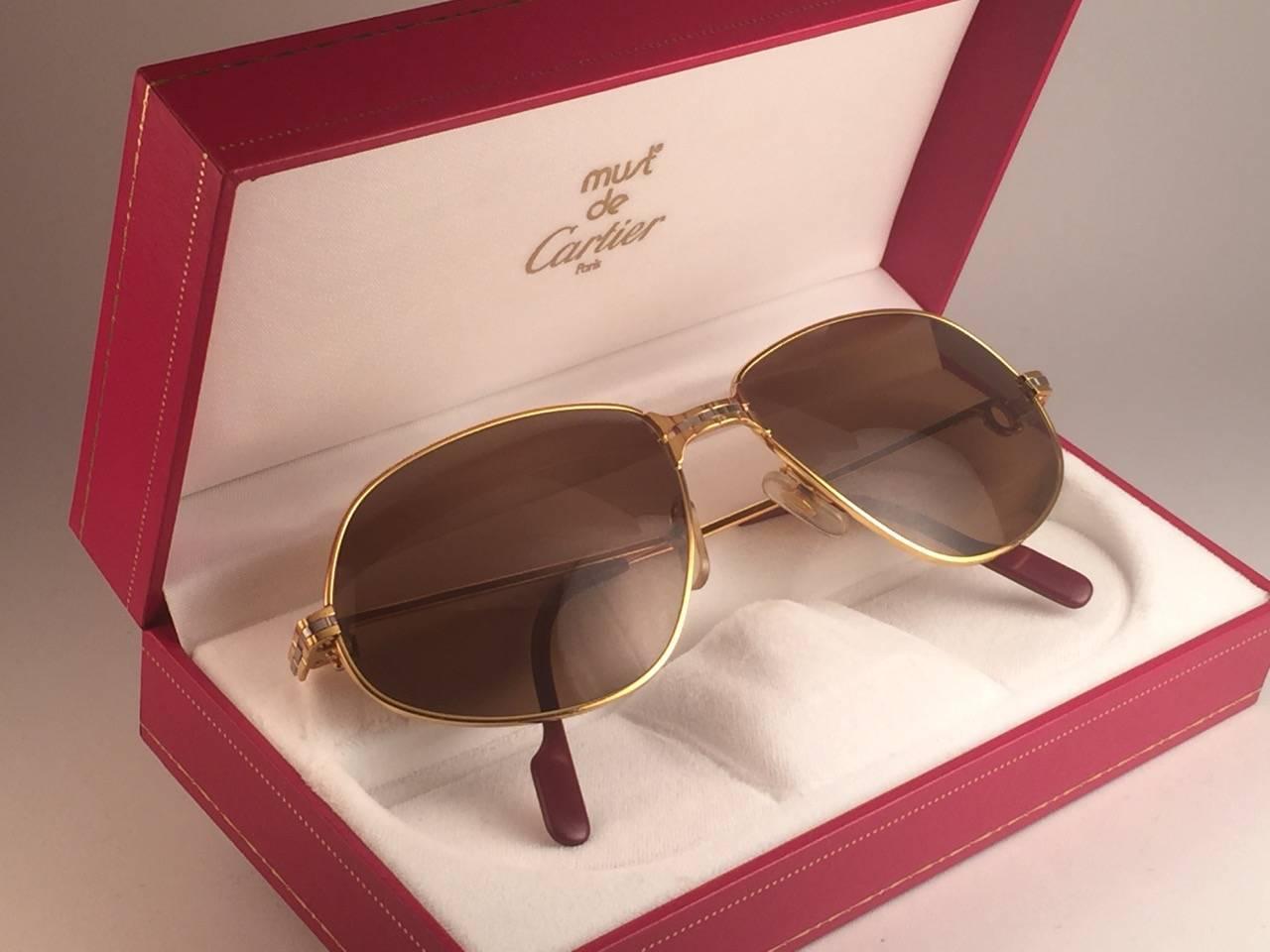 New 1988 Cartier Panthere unglasses with brown (uv protection) lenses. 
Frame is with the front and sides in yellow and white gold. All hallmarks. burgundy ear paddles. Both arms sport the C from Cartier on the temple. G
These are like a pair of