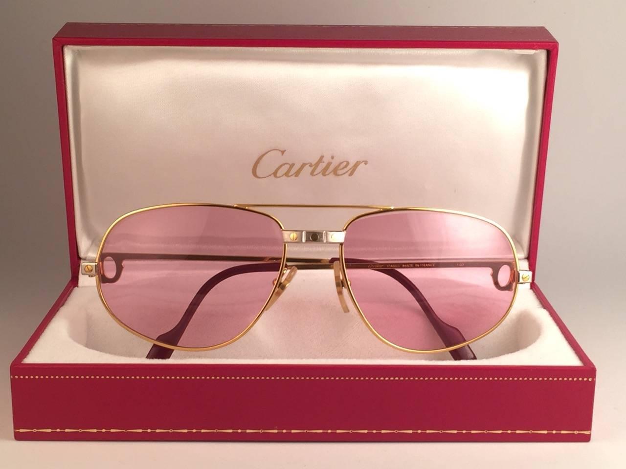 Mint Cartier Santos Romance sunglasses with !!! new !!! rose pink  (uv protection). not a spot on them, perfect! All hallmarks. 
Red enamel with Cartier gold signs on the earpaddles. Both arms sport the C from Cartier on the temple. 
These are like