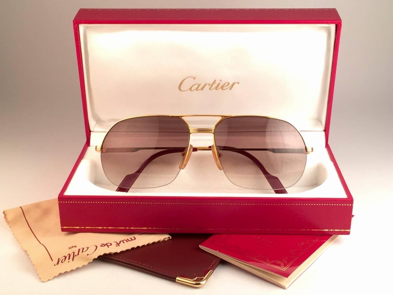 
New 1990 Cartier Tank Orsay Half Frame Sunglasses with brown (uv protection) lenses. 
Frame is with the front and sides in yellow and white gold. All hallmarks. Cartier gold signs on the ear paddles. These are like a pair of jewels on your nose