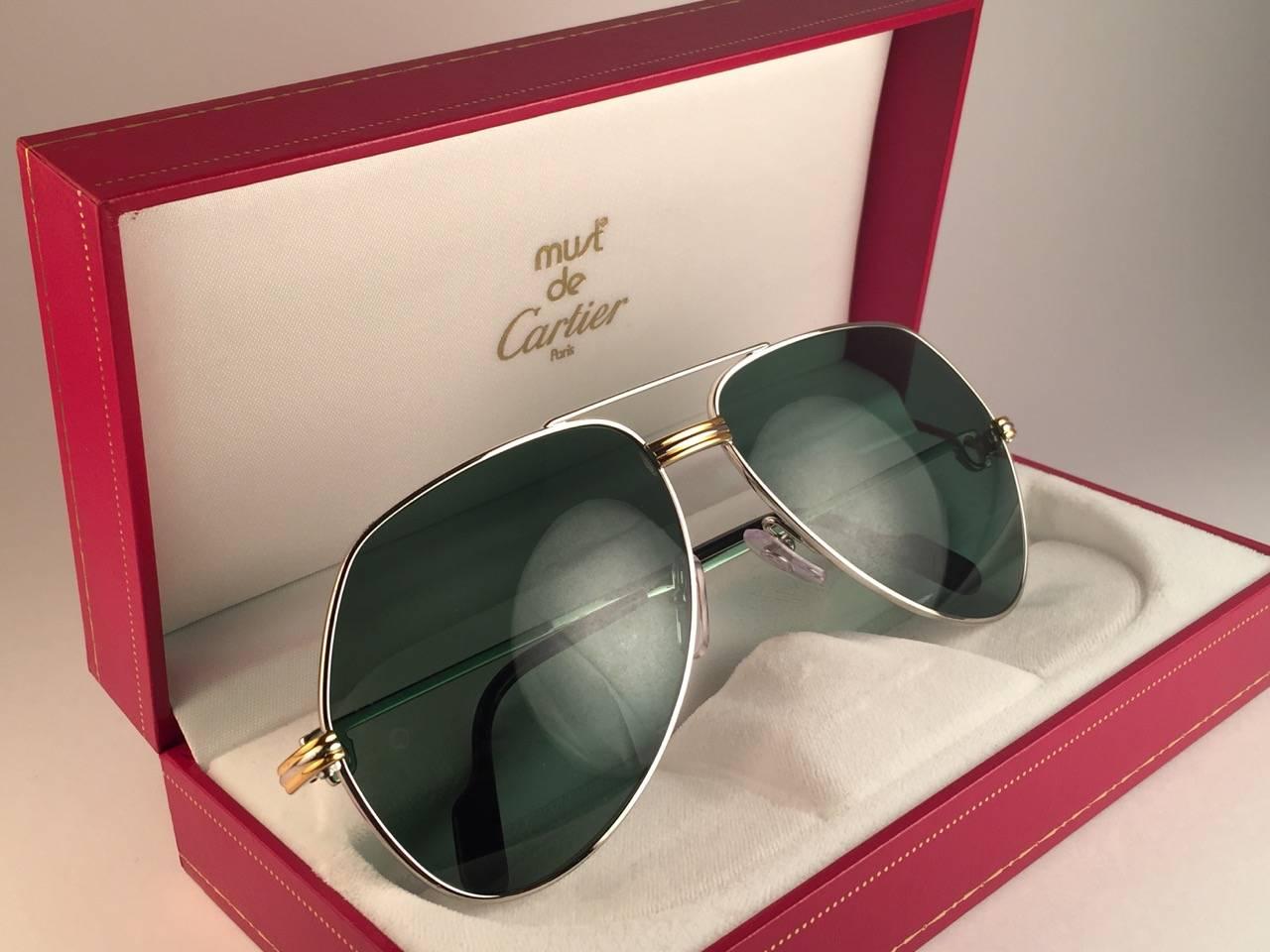 New 1983 Cartier Platinum Vendome sunglasses with original Cartier grey lenses (uv protection) 
The frame is with the front and sides in platinum & yellow gold.
All hallmarks. Black enamel with Cartier silver signs on the earpaddles. 
Both arms