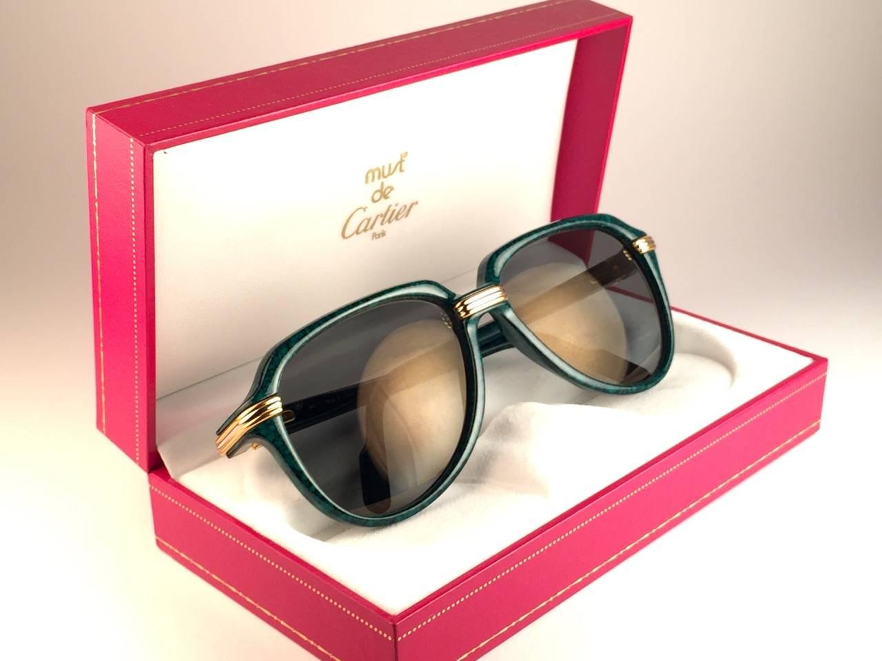 New Collectors Item. 
Unique and Rare Prototype Cartier Aviator Vitesse sunglasses, the Marbled Green Edition with yellow and white gold accents.
Frame is with the sides in gold and white hard plated gold. All hallmarks. Cartier gold signs on the