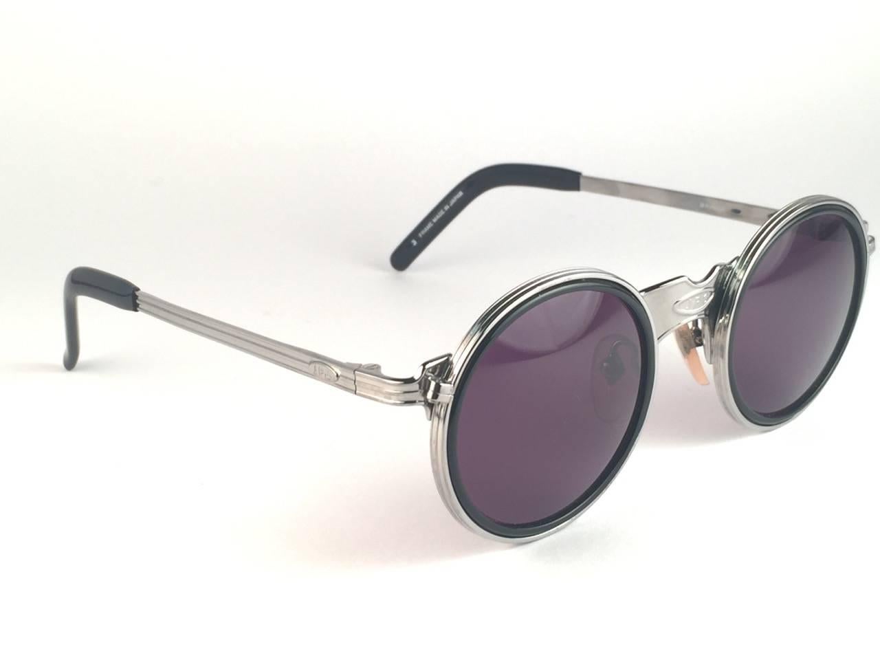 
New Jean Paul Gaultier 56 3272 Round silver frame with black inserts frame. 
Spotless dark grey lenses that complete a ready to wear JPG look.

Amazing design with strong yet intricate details.
Design and produced in the 1900's.
New, never worn or