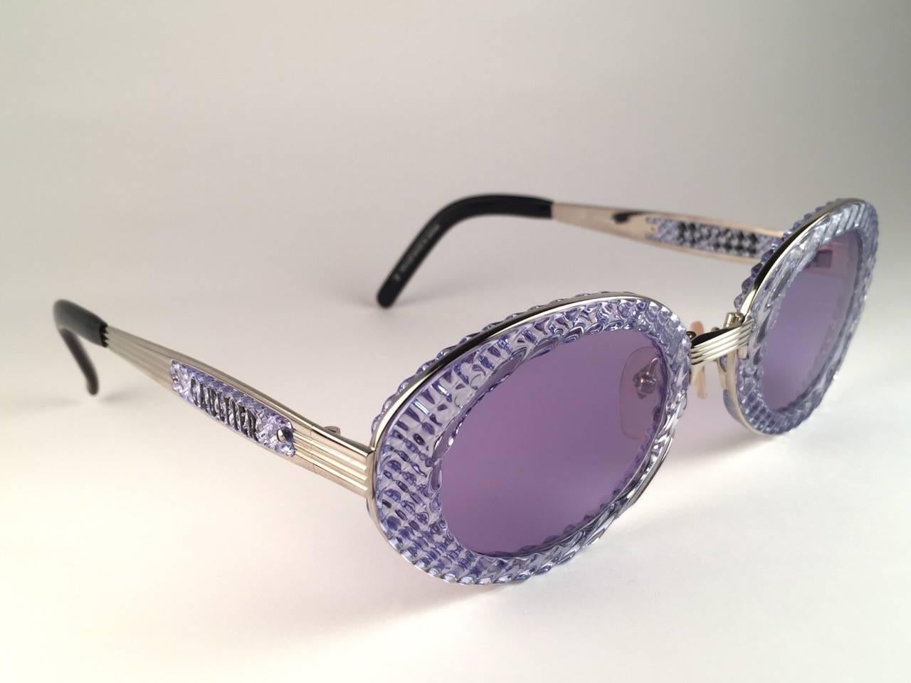 New Collectors Item!

New Jean Paul Gaultier 56 5201 Oval Blue Translucent frame with itemized details on the temples. 
Baby Blue lenses that complete a ready to wear JPG look.

Amazing design with strong yet intricate details.
Design and produced