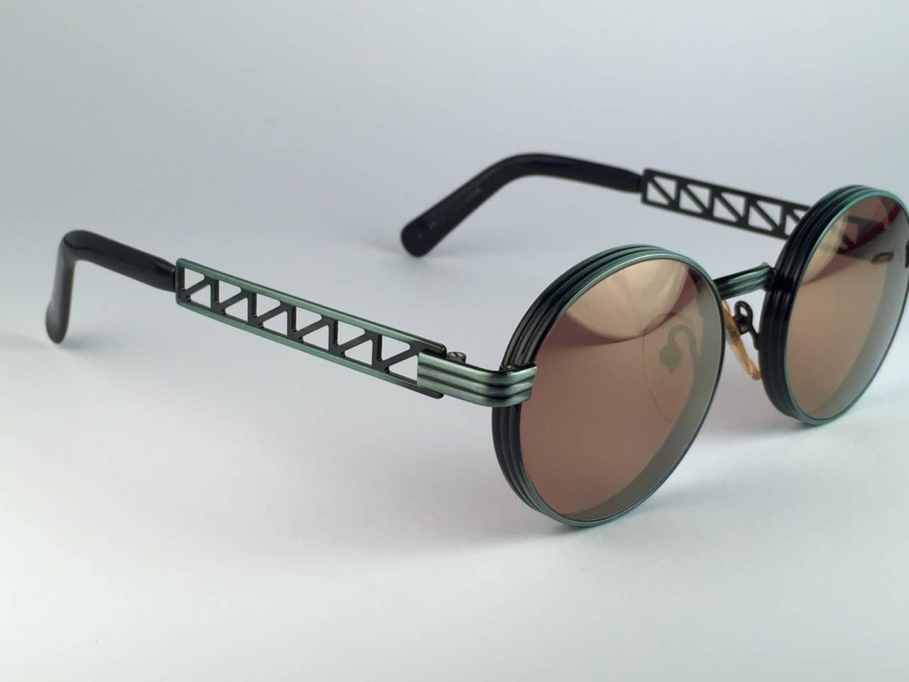 Superb Collectors Item!!
New Jean Paul Gaultier 56 0173 Eiffel Tower Series Ornaments on the temples over a emerald green frame. 
Spotless Amber mirror lenses that complete a ready to wear JPG look.

Amazing design with strong yet intricate