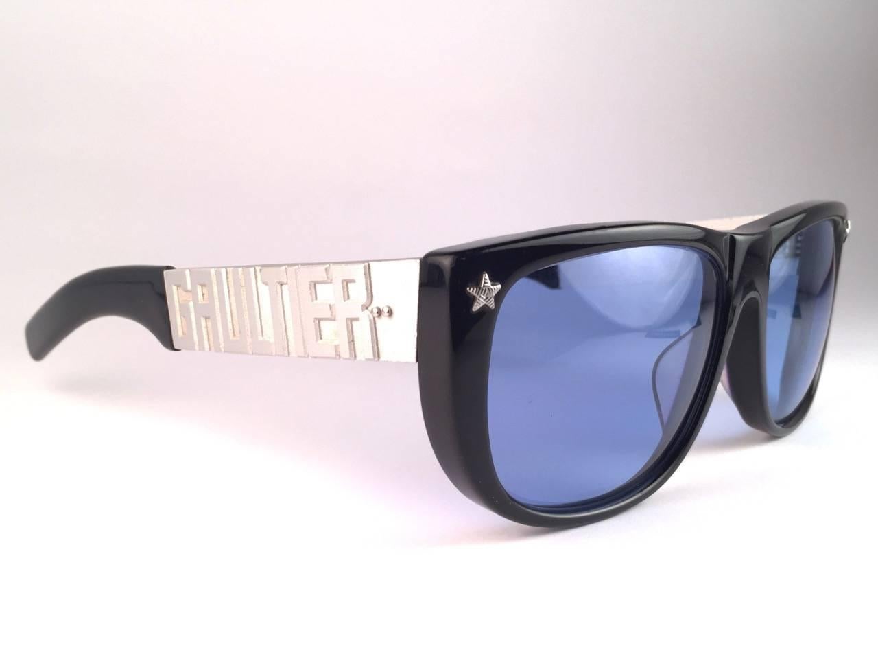 Collectors Item!!

Mint Iconic Jean Paul Gaultier 56 8272 Black with Silver Metal temples frame. 
Baby blue lenses that complete a ready to wear JPG look.
The very same model worn by Vanilla Ice in 1990's.
Amazing design with strong yet intricate