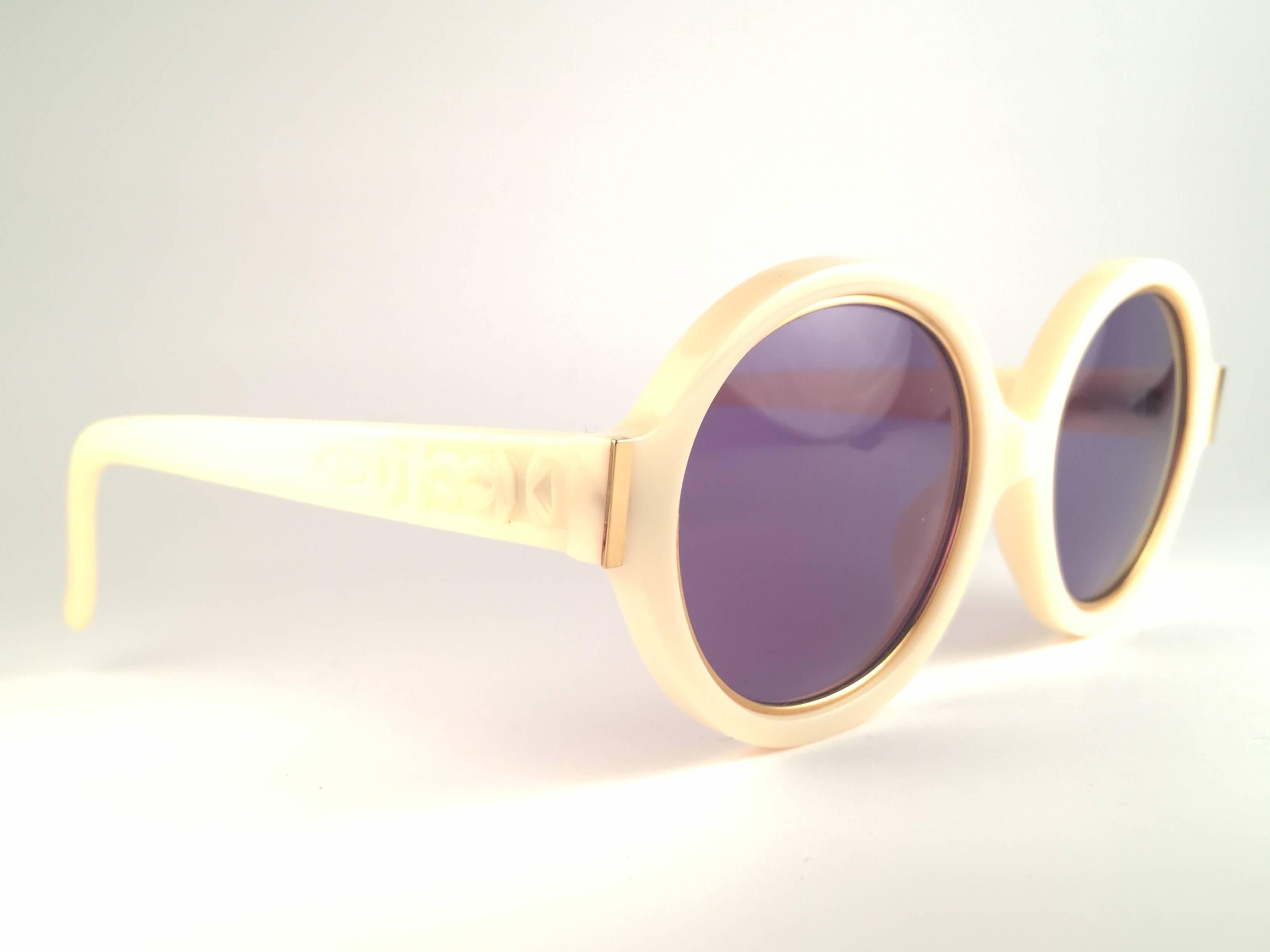 New Vintage Christian Dior 2446 70 Beige with gold inserts frame sporting spotless purple lenses. 

Made in Germany.
 
Produced and design in 1970's.

A collector’s piece!

New, never worn or displayed. Comes with its original silver Christian Dior
