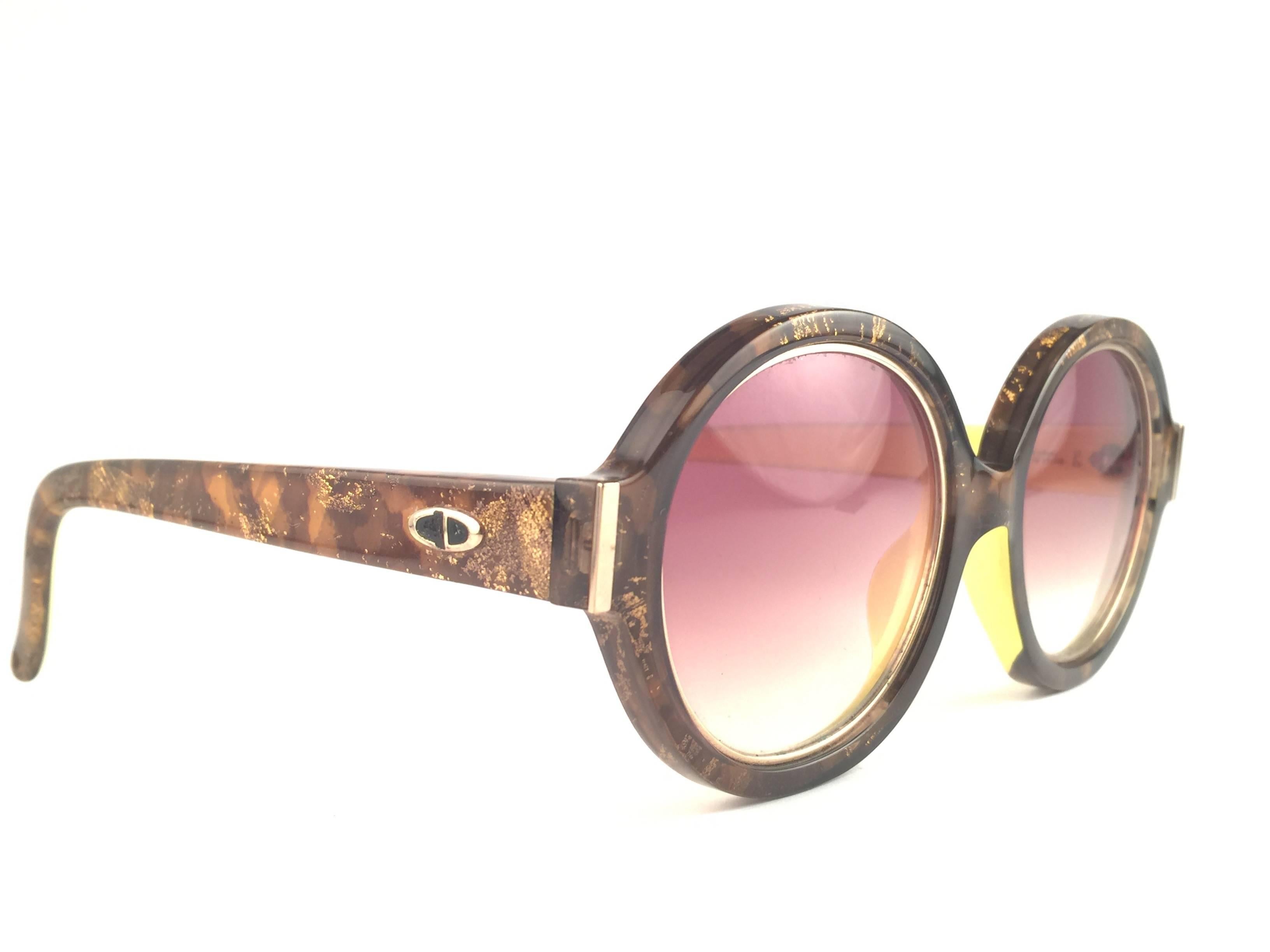 New Vintage Christian Dior 2446 20 Translucent amber mosaic with gold inserts frame sporting spotless brown gradient lenses. 

Made in Germany.
 
Produced and design in 1970's.

A collector’s piece!

New, never worn or displayed. Comes with its