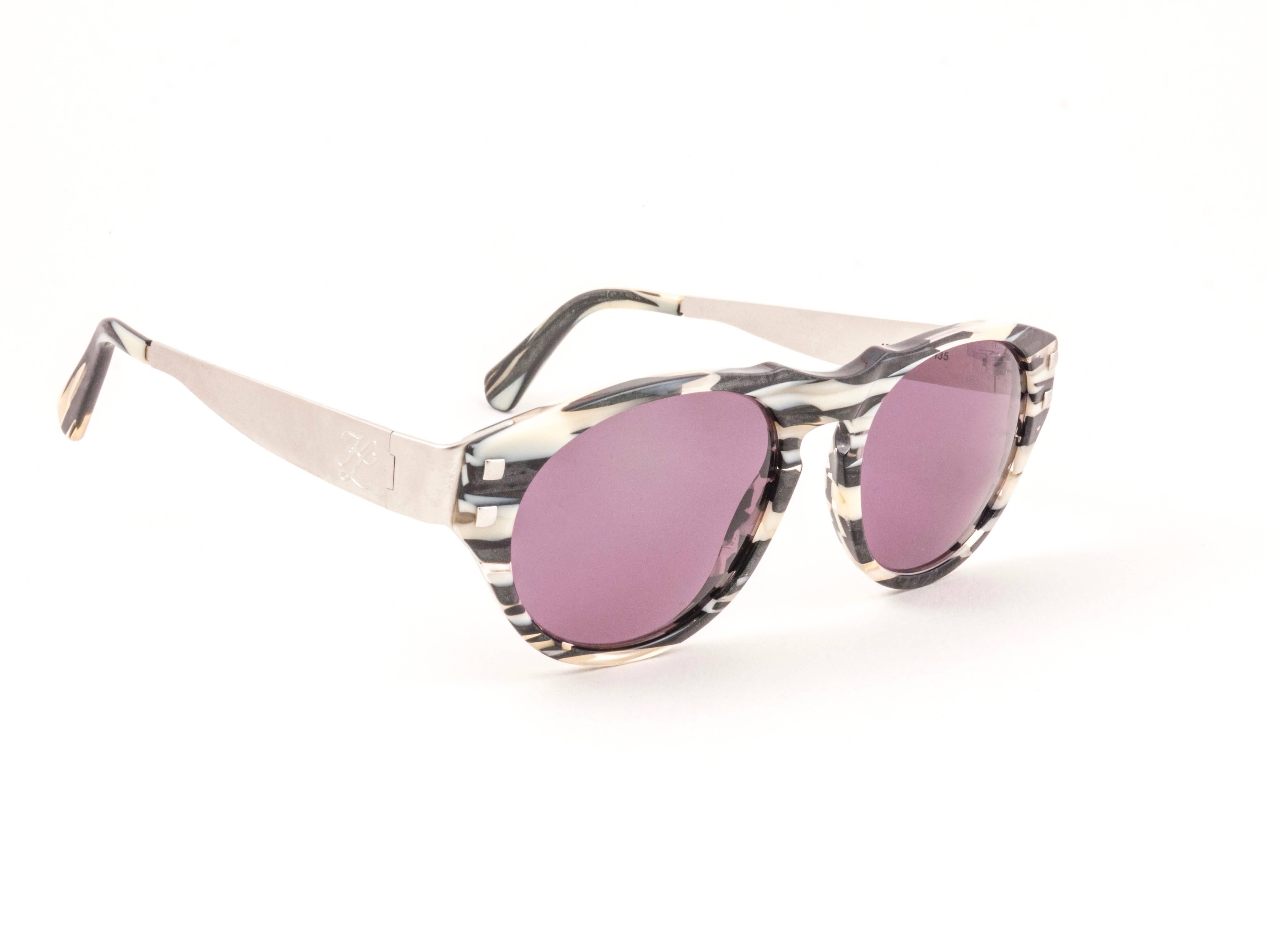 Amazing pair of New vintage 1980's 4602 b 135 Karl Lagerfeld black & white black mosaic sunglasses framing a pair of rose magenta lenses.
 
 New, never worn or displayed. A true fashion statement .