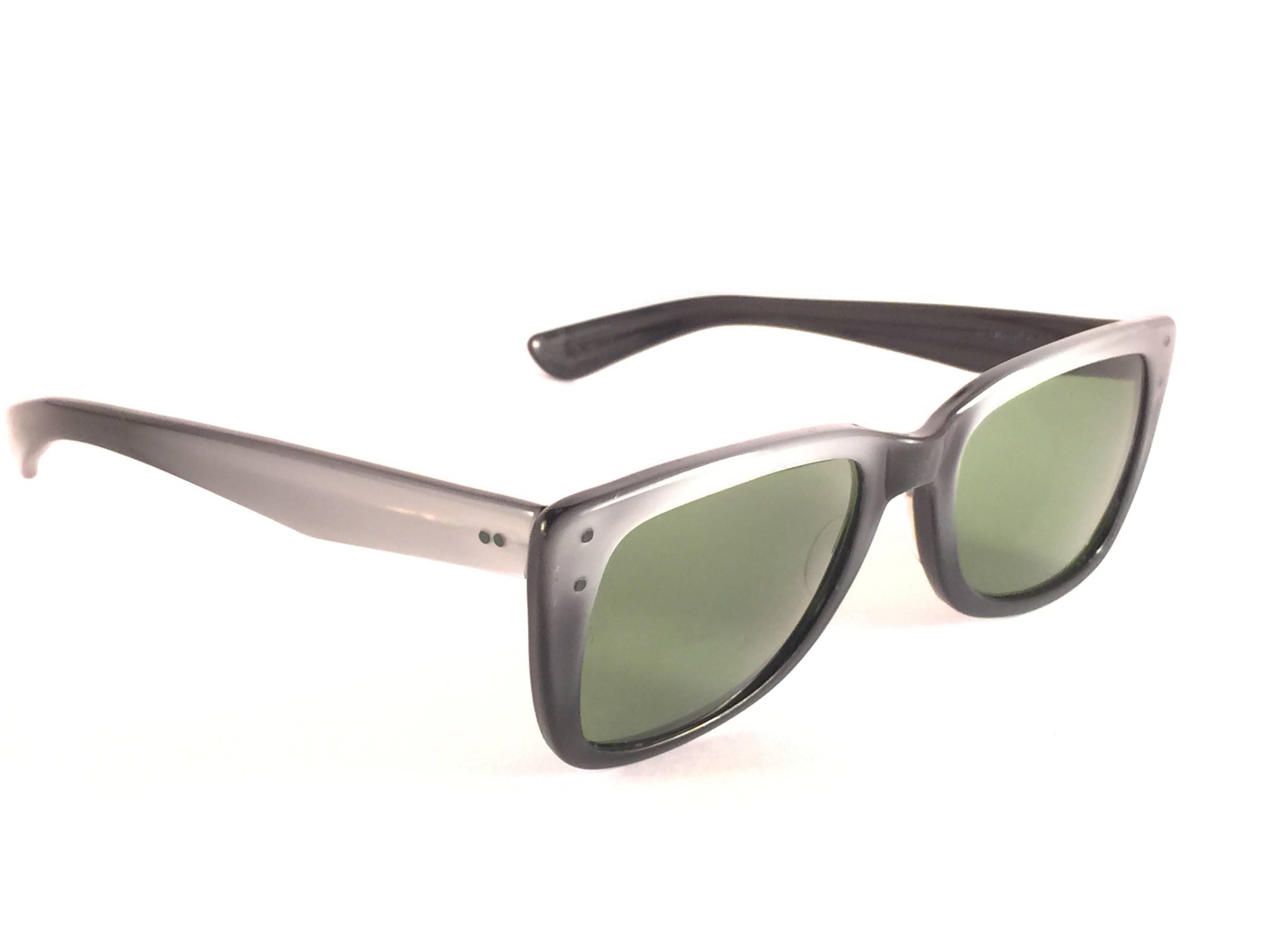 Super Rare 1960's Caribbean two tone metallic grey with thinner and elongated temples .  

Bausch and Lomb USA Made. G15 grey lenses. Straight out of the 1960's. 'All hallmarks. 
Minor sign of wear due to 60 years of storage. 
A Piece of sunglasses