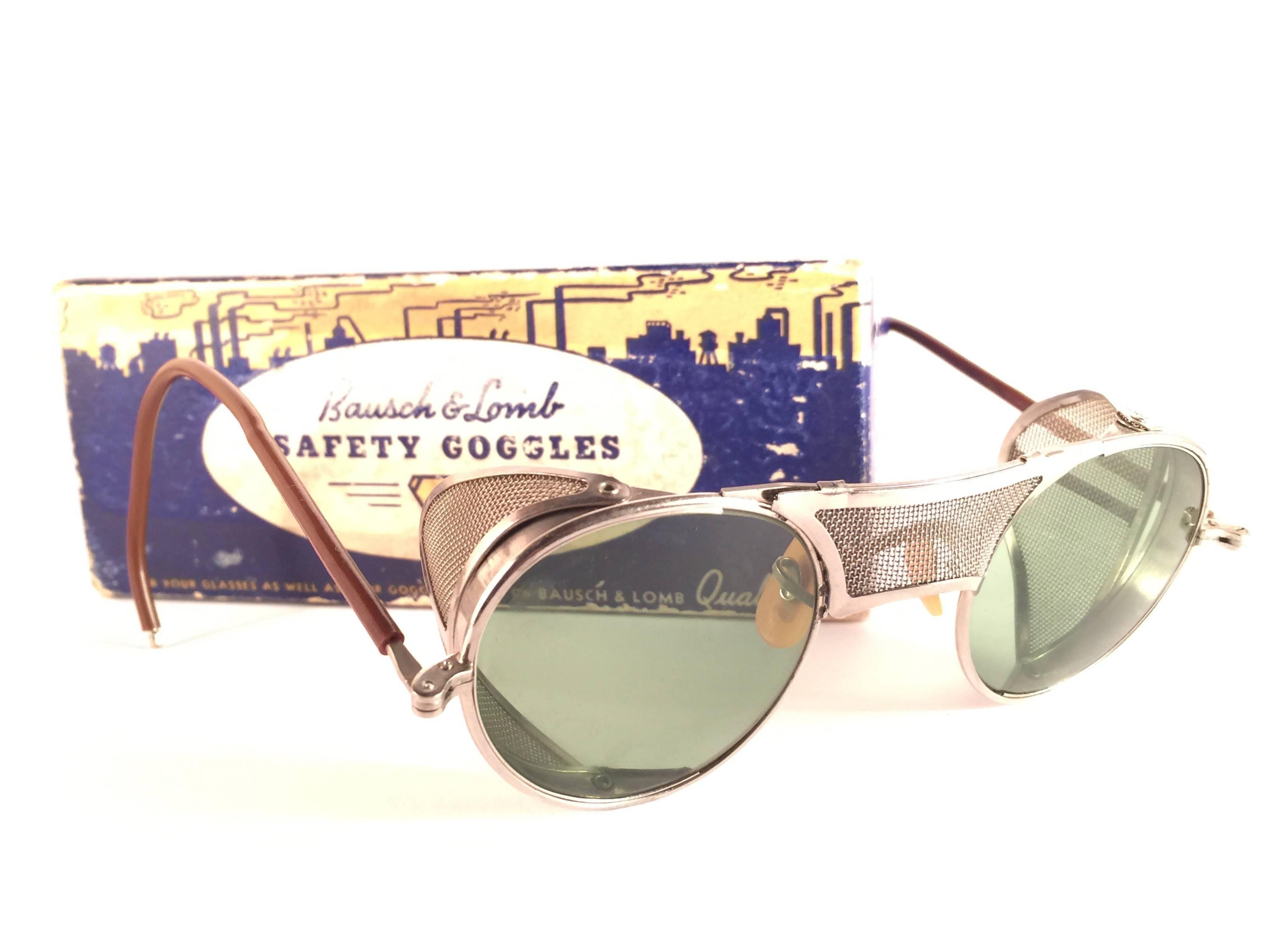 Superb Item!  
1950's Bausch & Lomb Safety Goggles. Folding silver metal side cups and special wrapped temples. Mint true green round lenses.  
A beautiful piece of sunglasses history.
