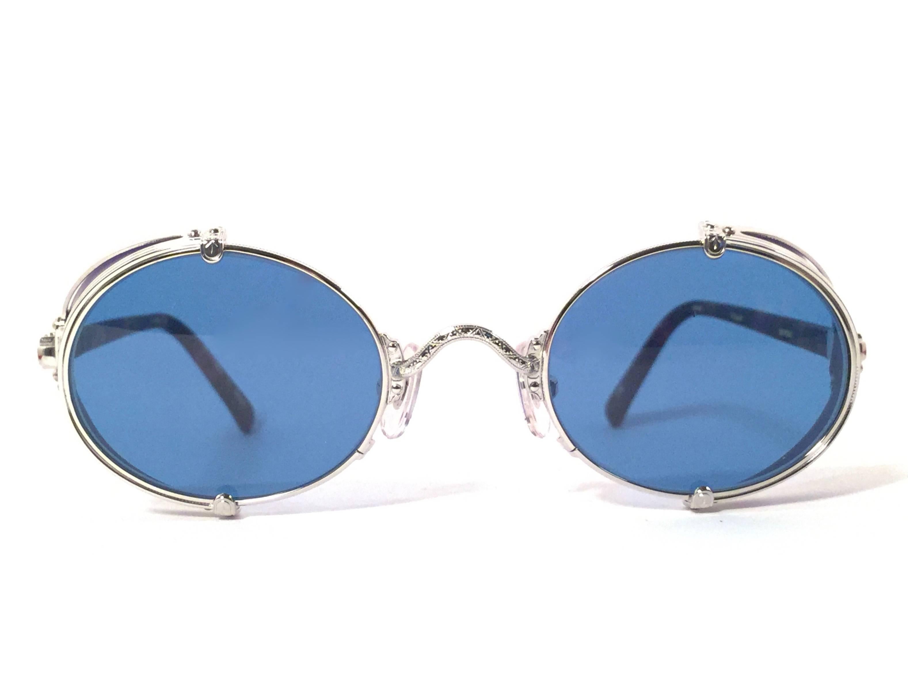 Cult brand Matsuda signed this ultra chic pair of round titanium with blue side cups sunglasses. 

Spotless blue lenses.

Superior quality and design. 

New, never worn or displayed. Made in japan.

