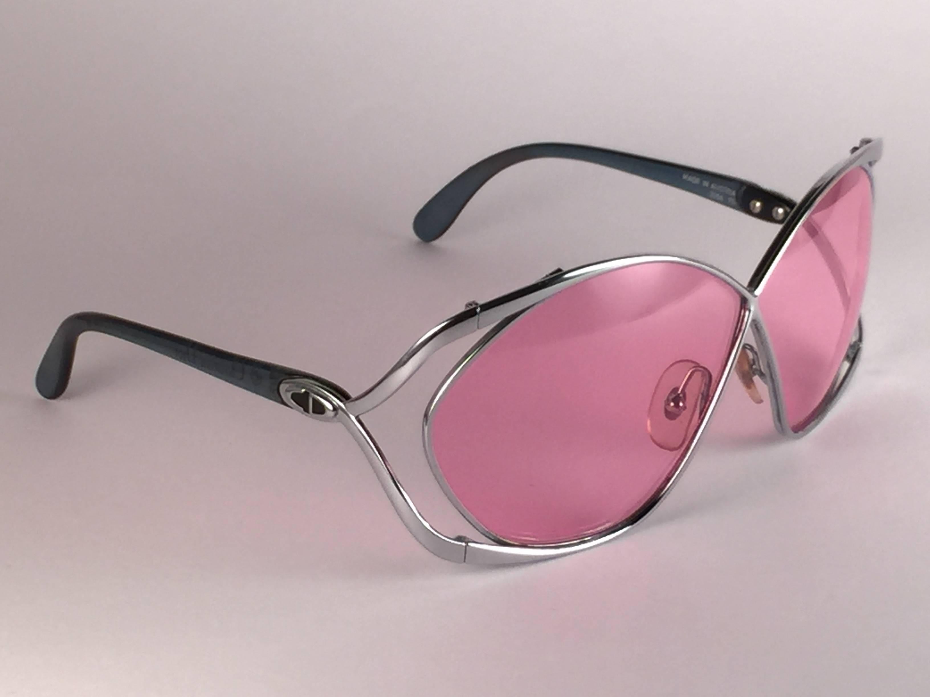  Highly coveted Christian Dior butterly shape in sleek silver. Spotless candy pink lenses. A collector’s piece!  Come with its original Christian Dior lunettes sleeve.  New, never worn or displayed. Made in Austria.