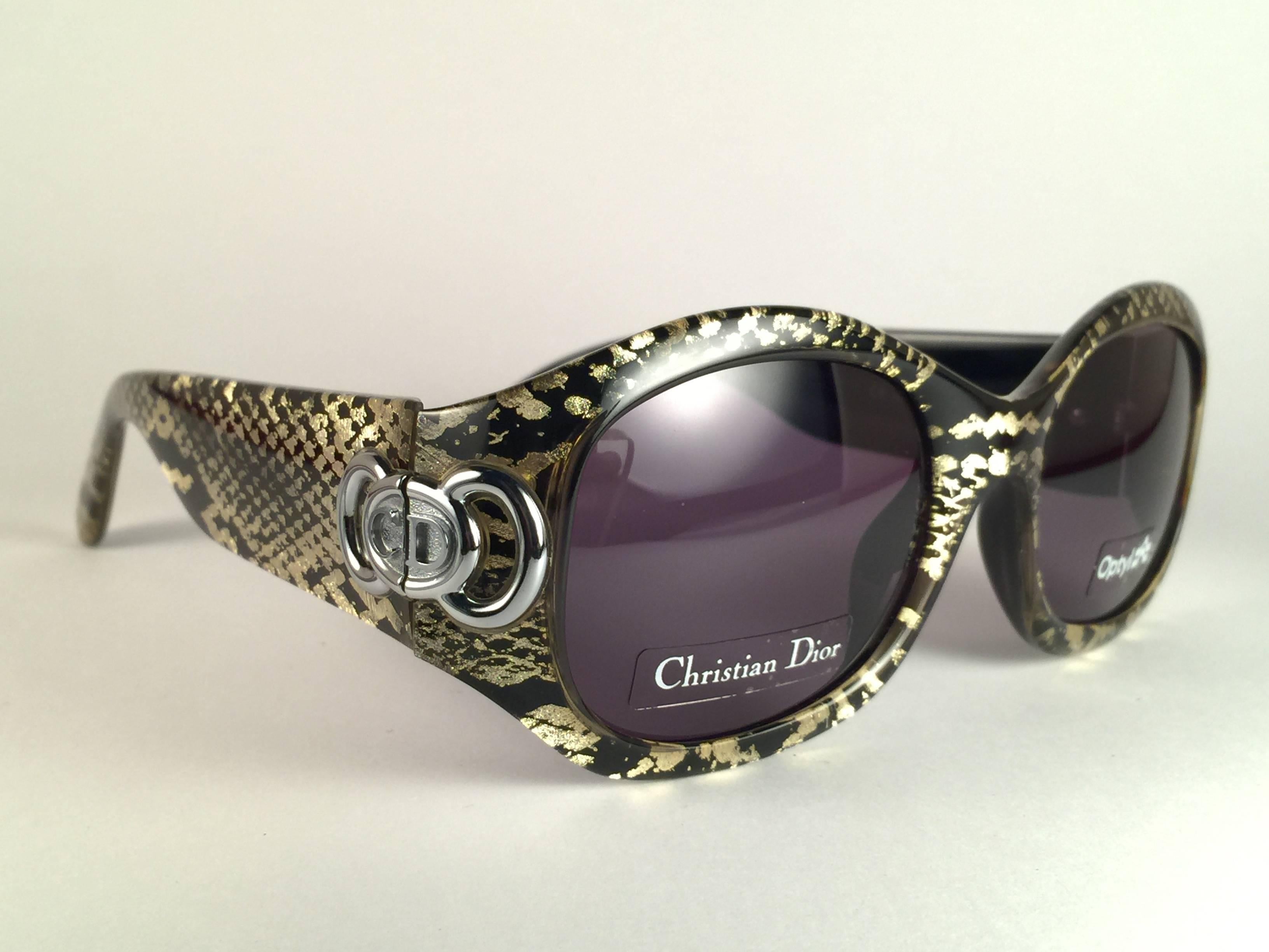 Eye catching vintage Christian Dior 2958 1990’s sunglasses made by optyl. 
Strong and stunning frame emulating a gold snake skin print. Lenses are spotless dark grey.
 
New, never worn or displayed. Flawless pair!


