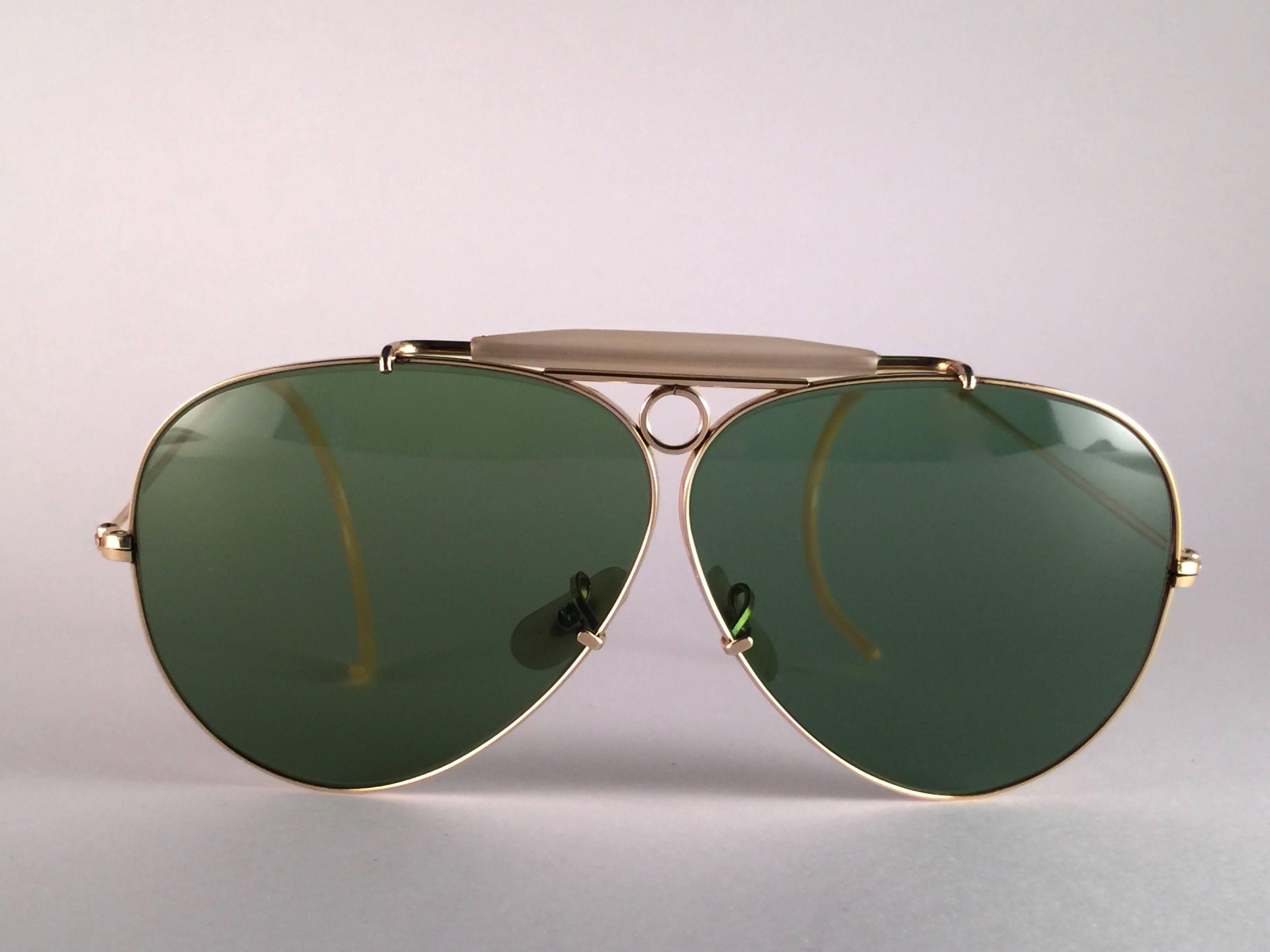 Superb pair Of Ray Ban Classic Shooter 62Mm with 12K gold filled frame.  1950's USA Made by Bausch and Lomb. Original True Green RB3 B&L lenses. Frame straight as an arrow with delicate filigree ornaments on the temples. 
All the hallmarks. Marked