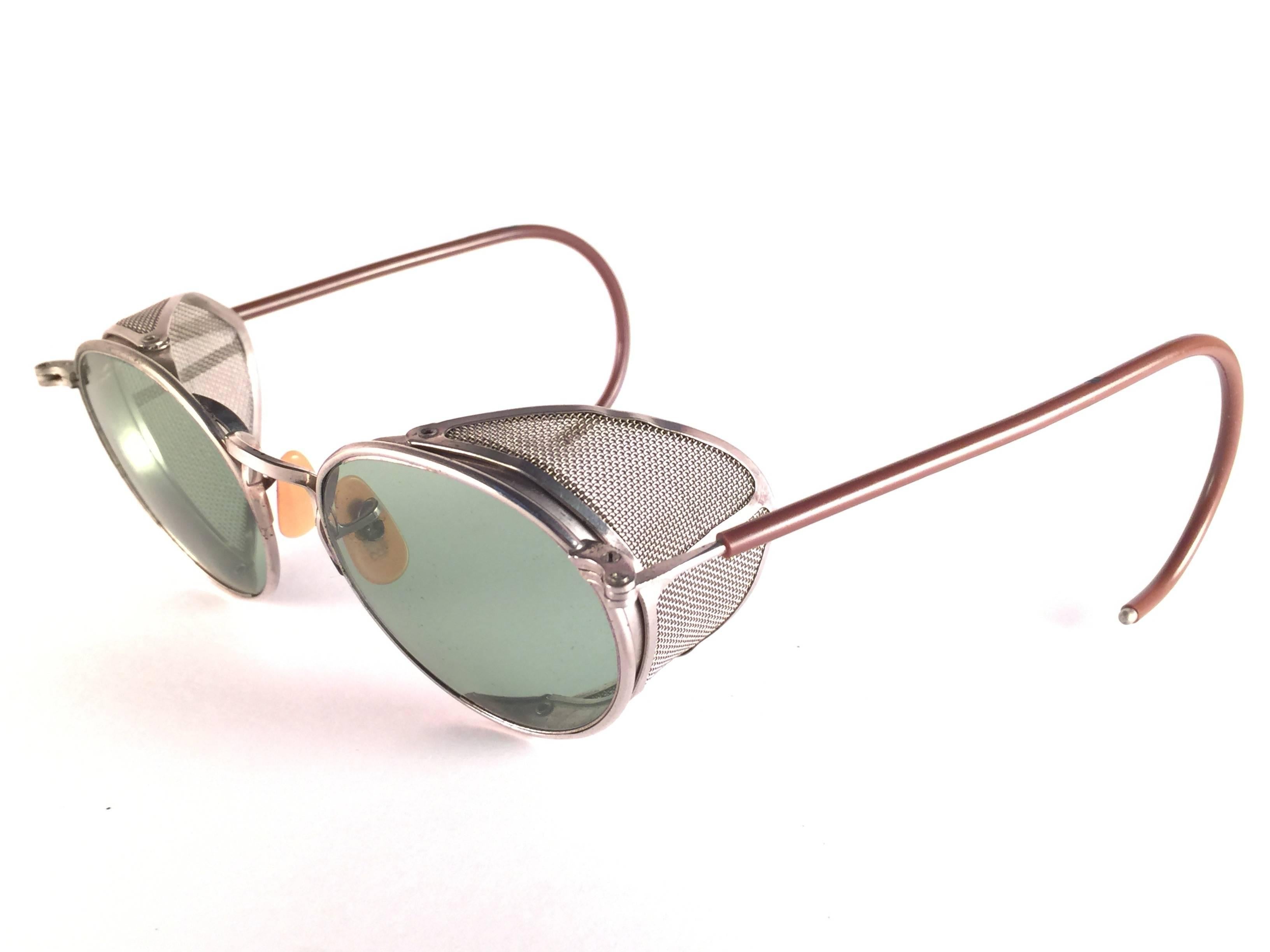 Superb Item!  1950's Bausch & Lomb Safety Goggles. 
Folding silver metal side cups and special wrapped temples. 
Mint true green round lenses with light wear on them. Please note that this item is nearly 70 years old and has some ageing patina on