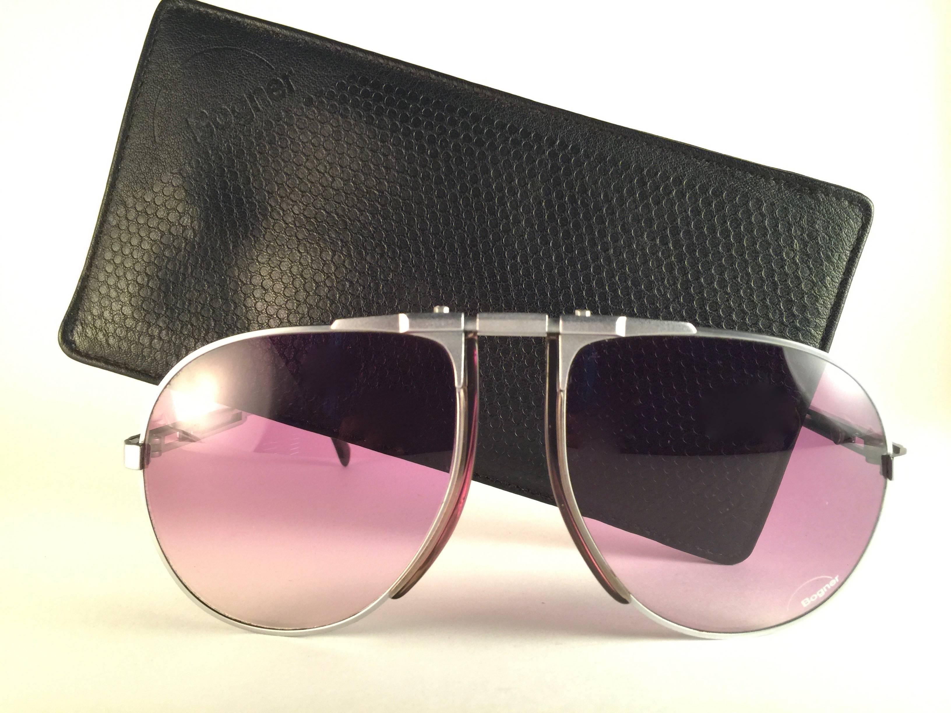 Collector's item.  
New vintage Bogner by Eschenbach sunglasses 7004 11 in matte silver with rose gradient lenses. The model is from the same series used by the late Roger Moore in 007's 