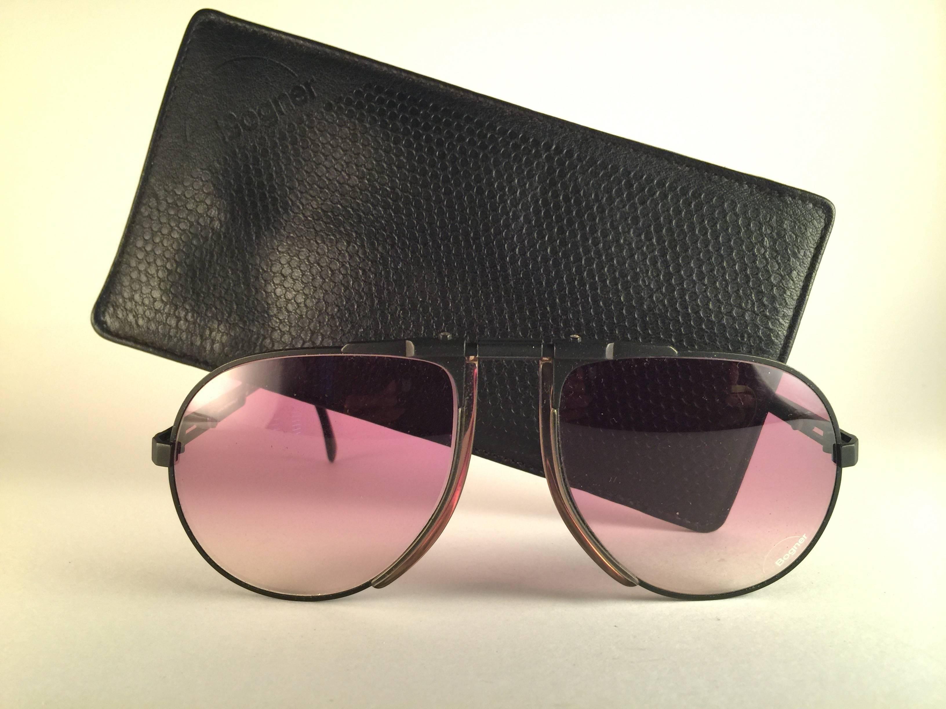 Collector's item.  
New vintage Bogner by Eschenbach sunglasses 7001 in matte black with rose gradient lenses. The model is from the same series used by the late Roger Moore in 007's 