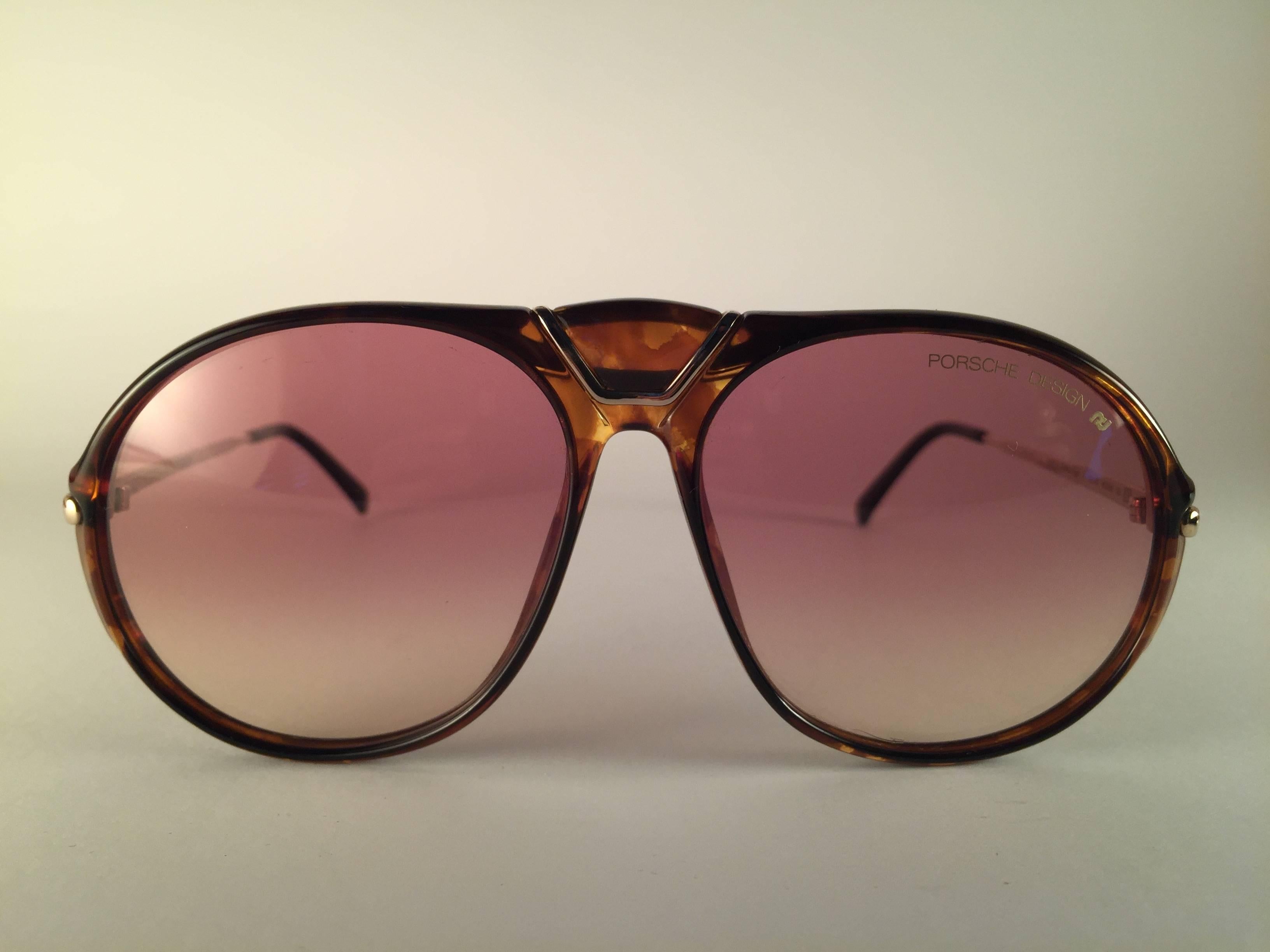 New 1980's Porsche Design 5659 Medium Tortoise and gold frame with light brown gradient lenses.  
Amazing craftsmanship and quality.  
Comes with the original Porsche hard case thats has some wear on it due to nearly 40 years of storage. 
There is