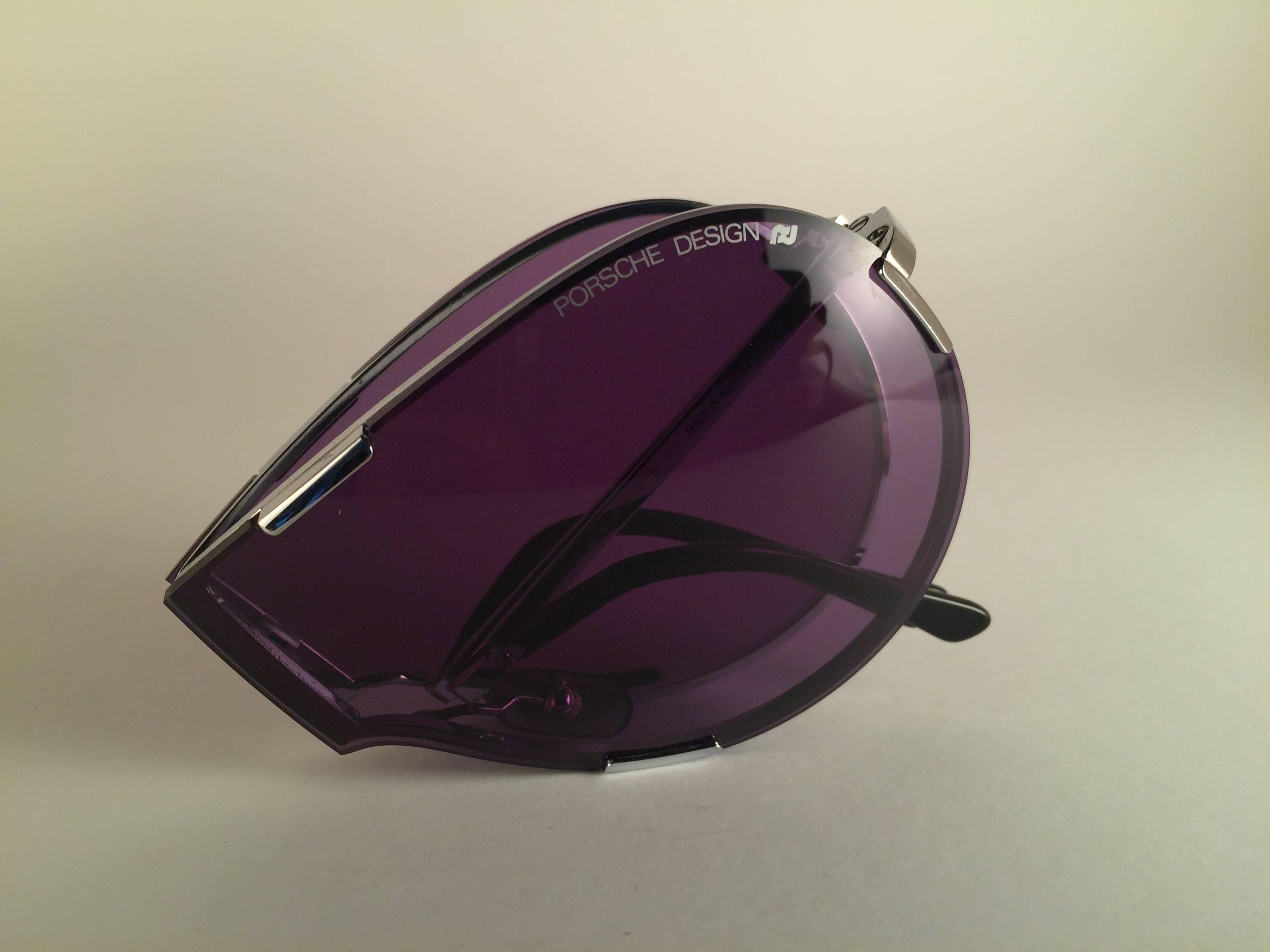 New 1980's Porsche Design 5629 Silver foldable frame with purple lenses.  Amazing craftsmanship and quality.  Comes with the original Porsche hard case thats has some wear on it due to nearly 40 years of storage. 
New, never worn. Made in Austria.