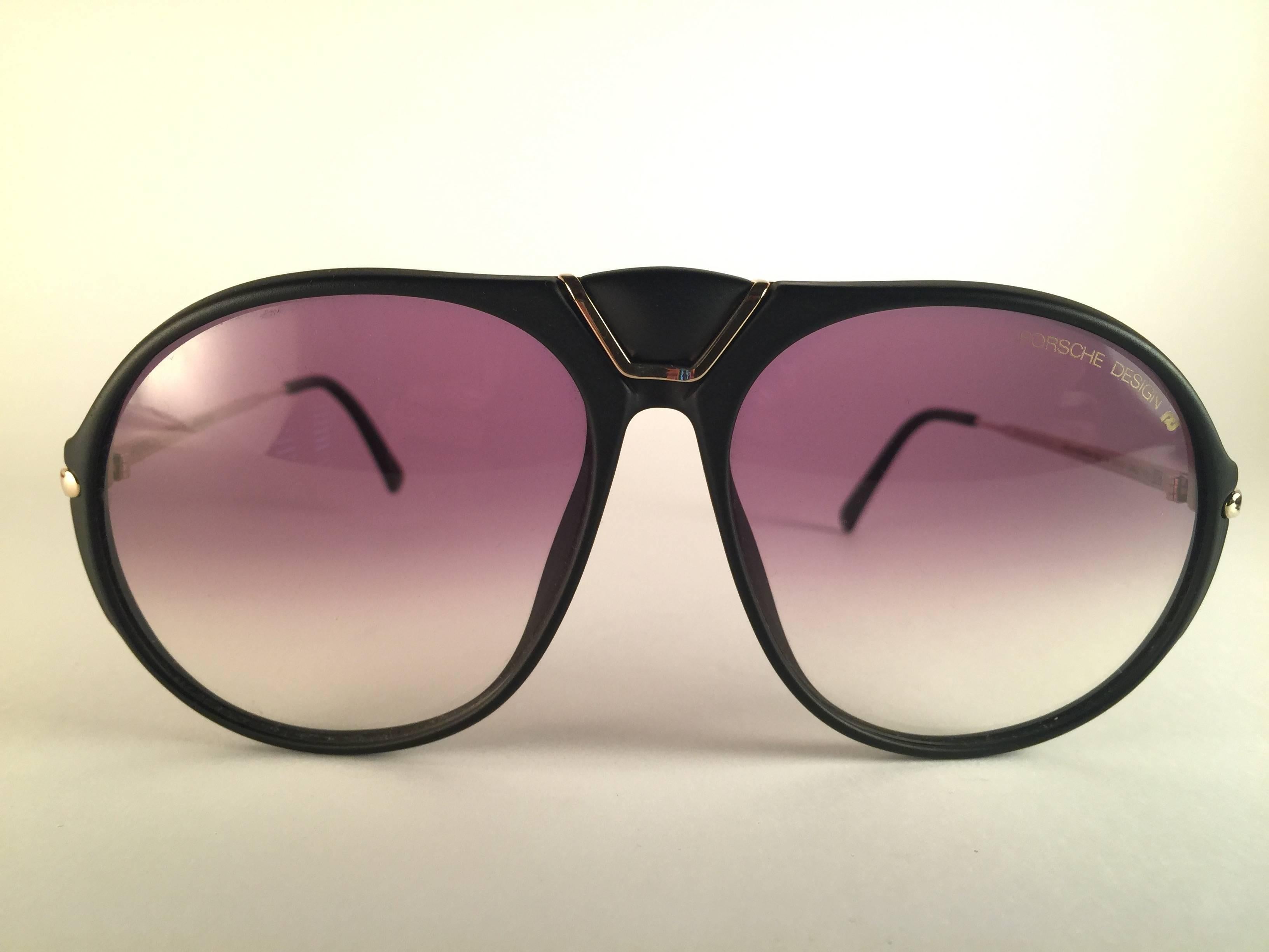New 1980's Porsche Design 5659 Large Black and gold frame with light brown gradient lenses.  
Amazing craftsmanship and quality.  
Comes with the original Porsche hard case thats has some wear on it due to nearly 40 years of storage.  There is no