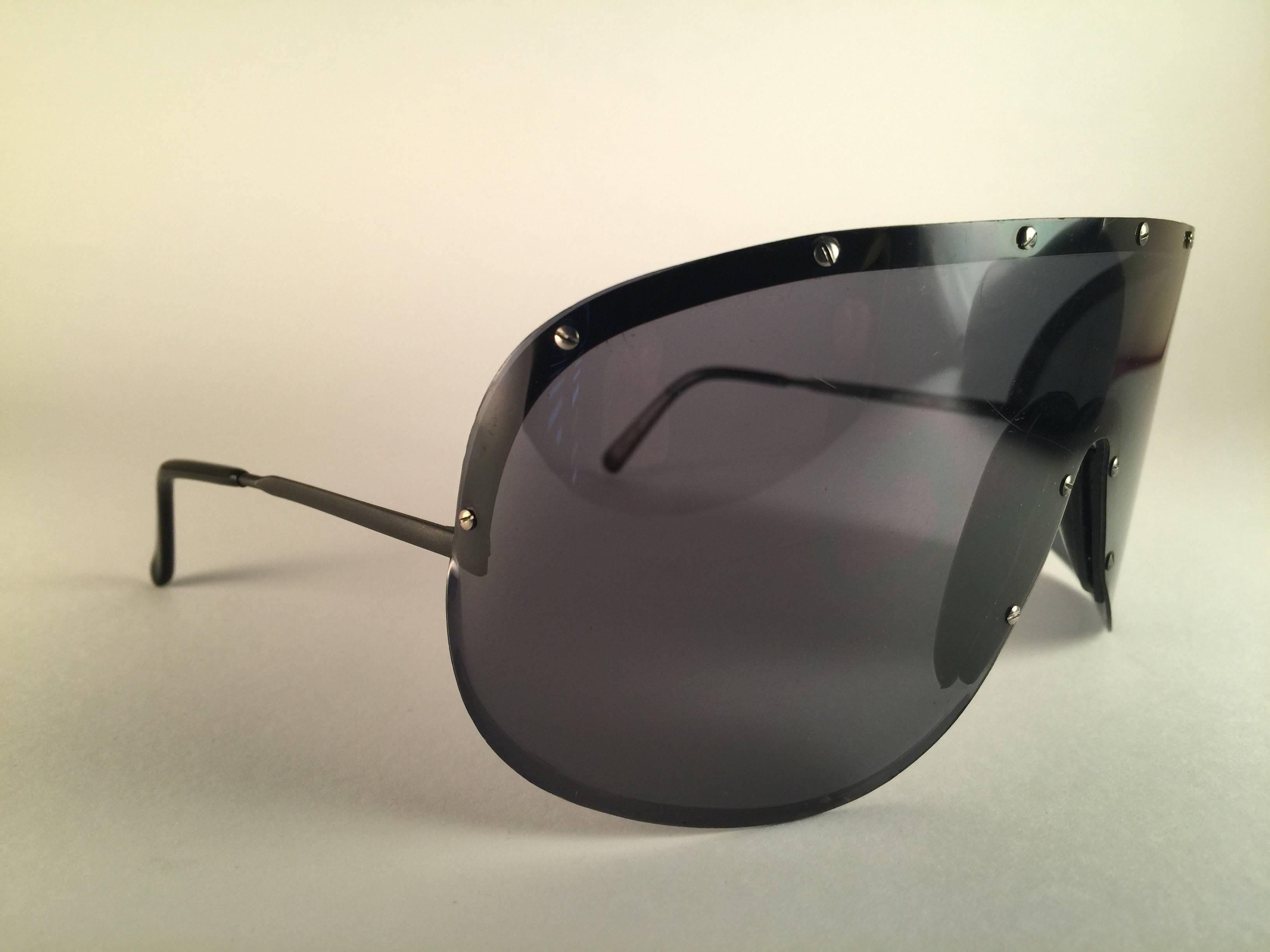 New and ultra rare collectors item from the 1980's, 30 years old Porsche Design 5620 Matte Black shield frame with smoke grey mono lens.  
Amazing craftsmanship and quality. 
it has minor wear on the mono lens. 
The very same model worn by yoko ono