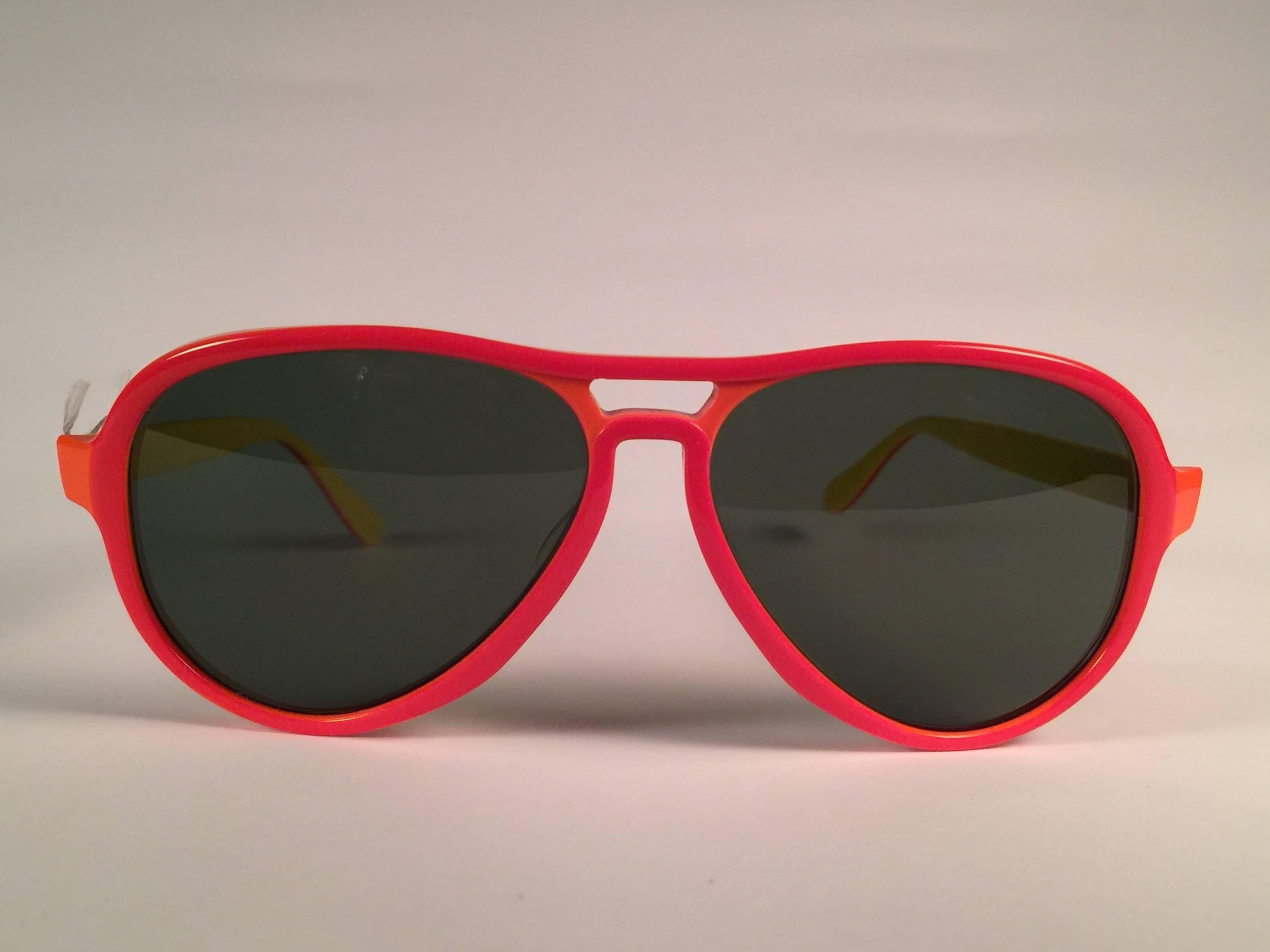 New and rare vintage Vagabond orange & yellow frame holding a spotless pair of G15 grey lenses.  
New, never worn or displayed. 
This pair may have minor sign of wear due to nearly 40 years of storage.   Designed and Produced in USA.