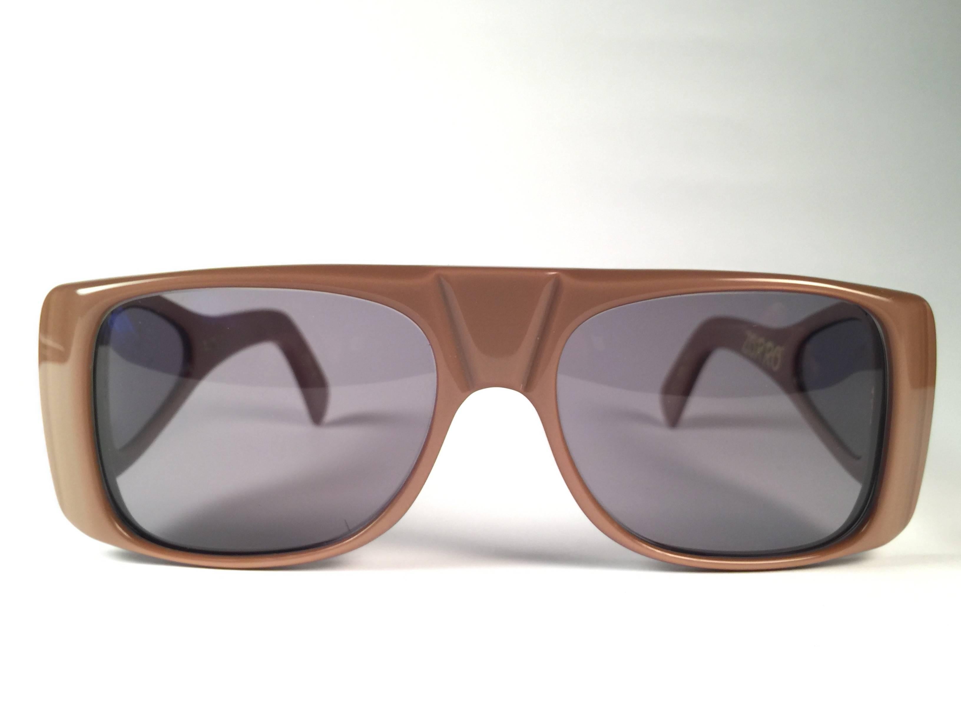 New Vintage Ultra " Zorro " toffee sunglasses. Cut out frame sporting a pair of brown lenses.  Never worn or displayed. This item may show minor sign of wear due to nearly 40 years of storage.  Designed and produced in England.