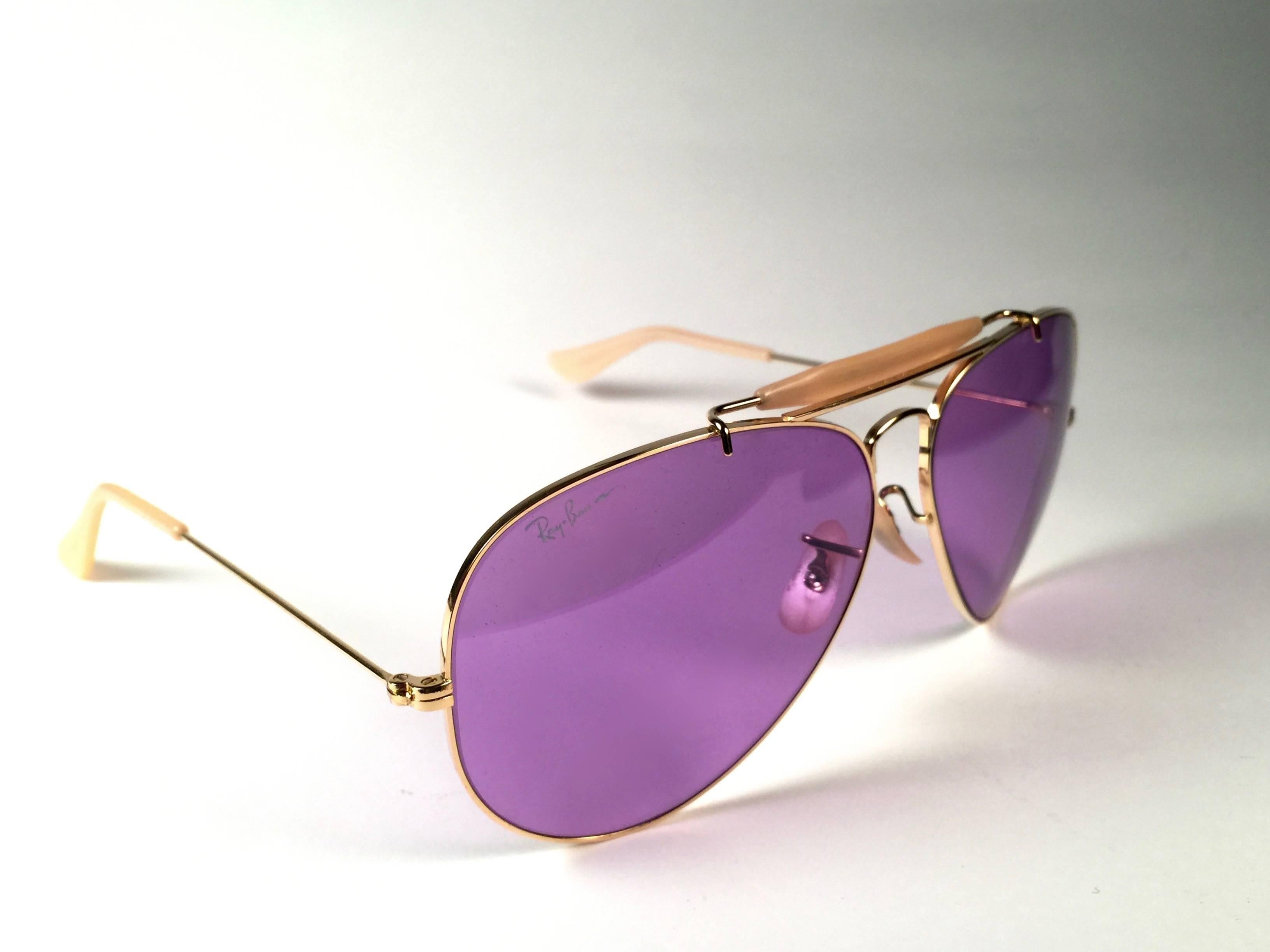 New, rare and sought after Vintage Ray Ban Purple Chromax. 
62Mm outdoorsman gold frame holding a pair of purple Chromax B&L etched lenses.

New, never worn or displayed, this item is a superb find.
It may have minor sign of wear due to storage.