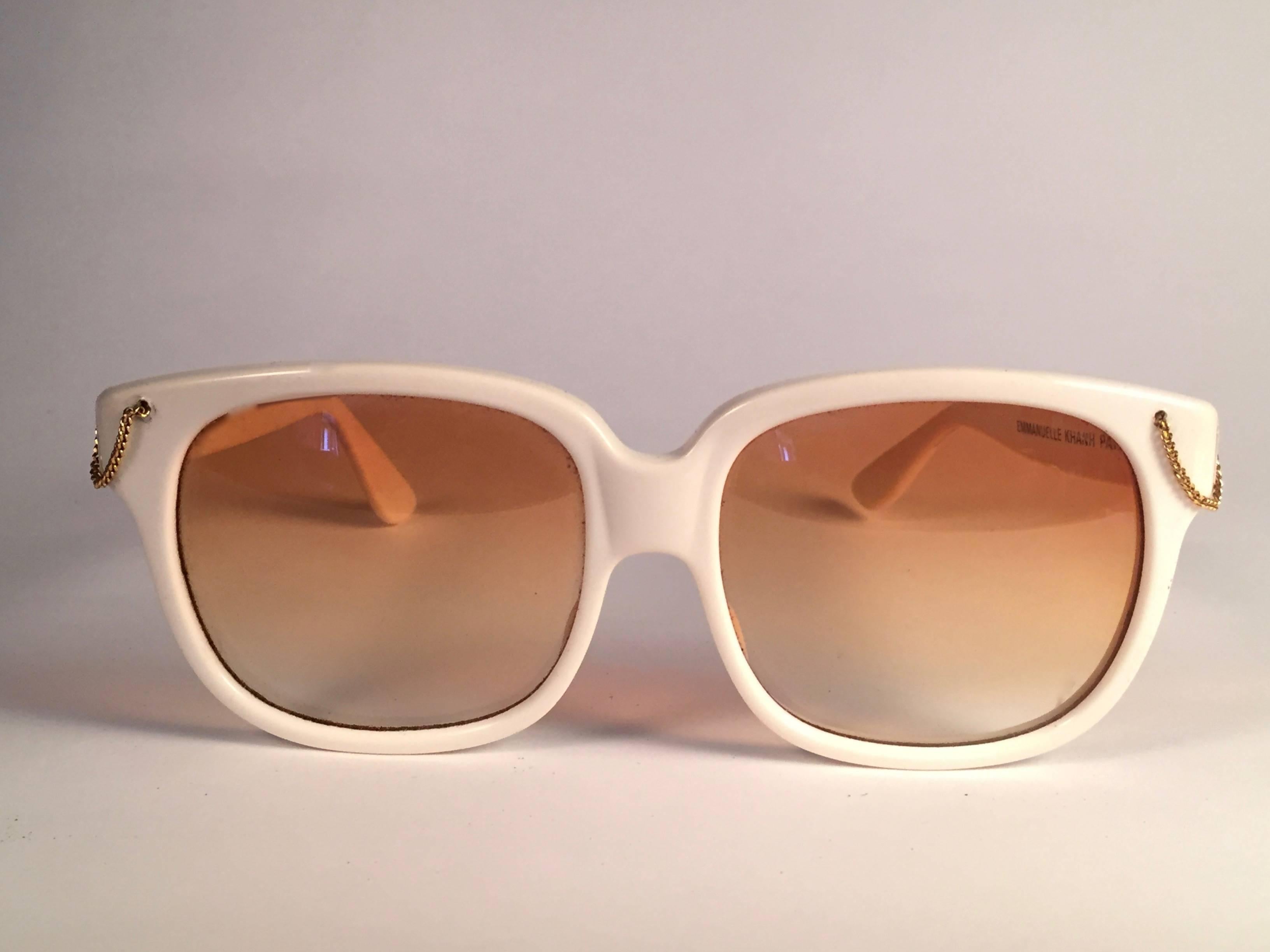 New Vintage Emanuelle Kahn White with gold chain detailed frame with spotless smoke orange gradient lenses.  Made in Paris. 
Produced and design in 1980's.  
New, never worn or displayed. Please consider this item is nearly 40 years old and could