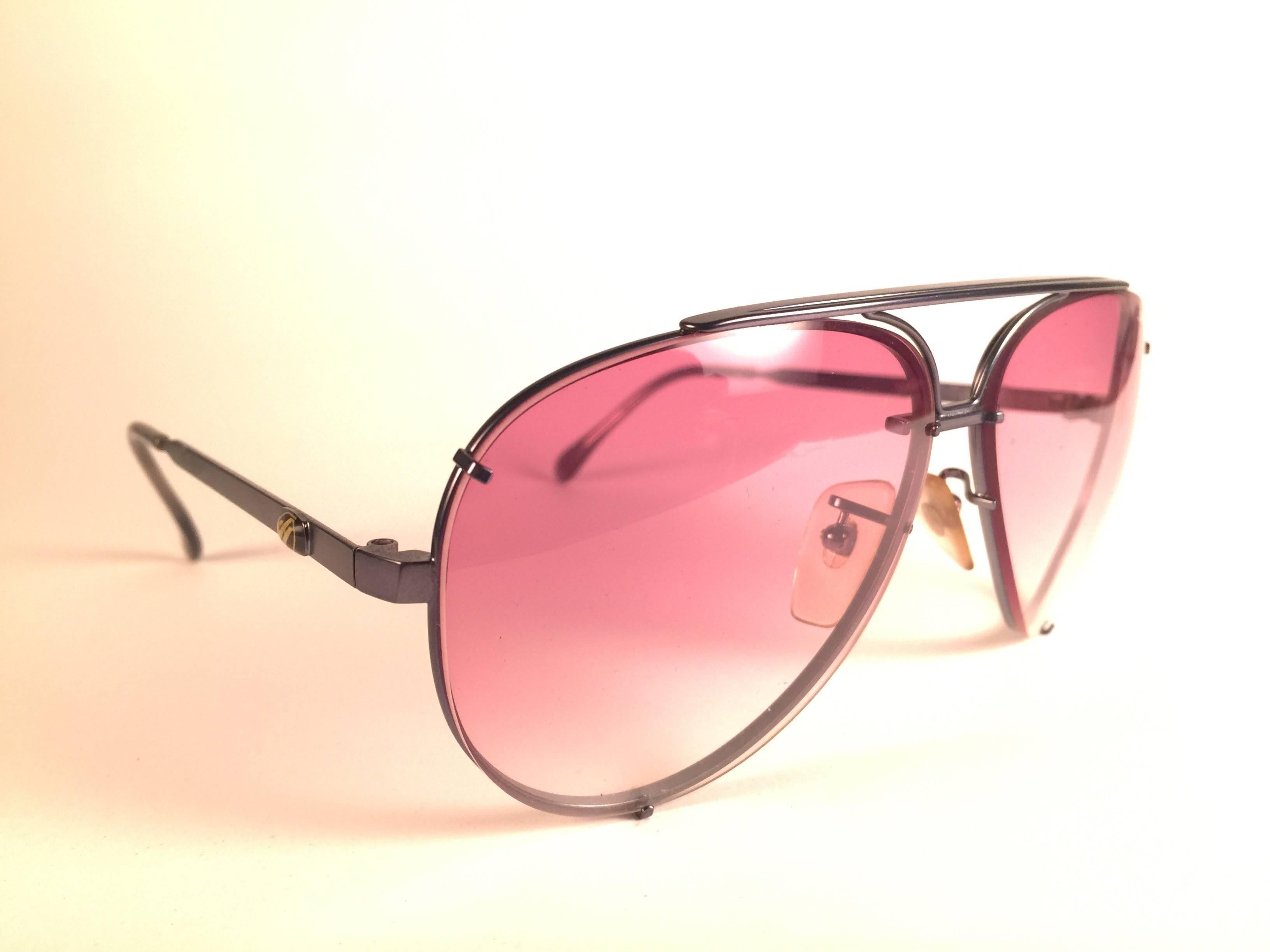 New Vintage Julio Iglesias Design sunglasses gun metal frame holding  pair pf rose gradient lenses. This pair may show minor sign of wear due to nearly 40 years of storage.

Made in France.