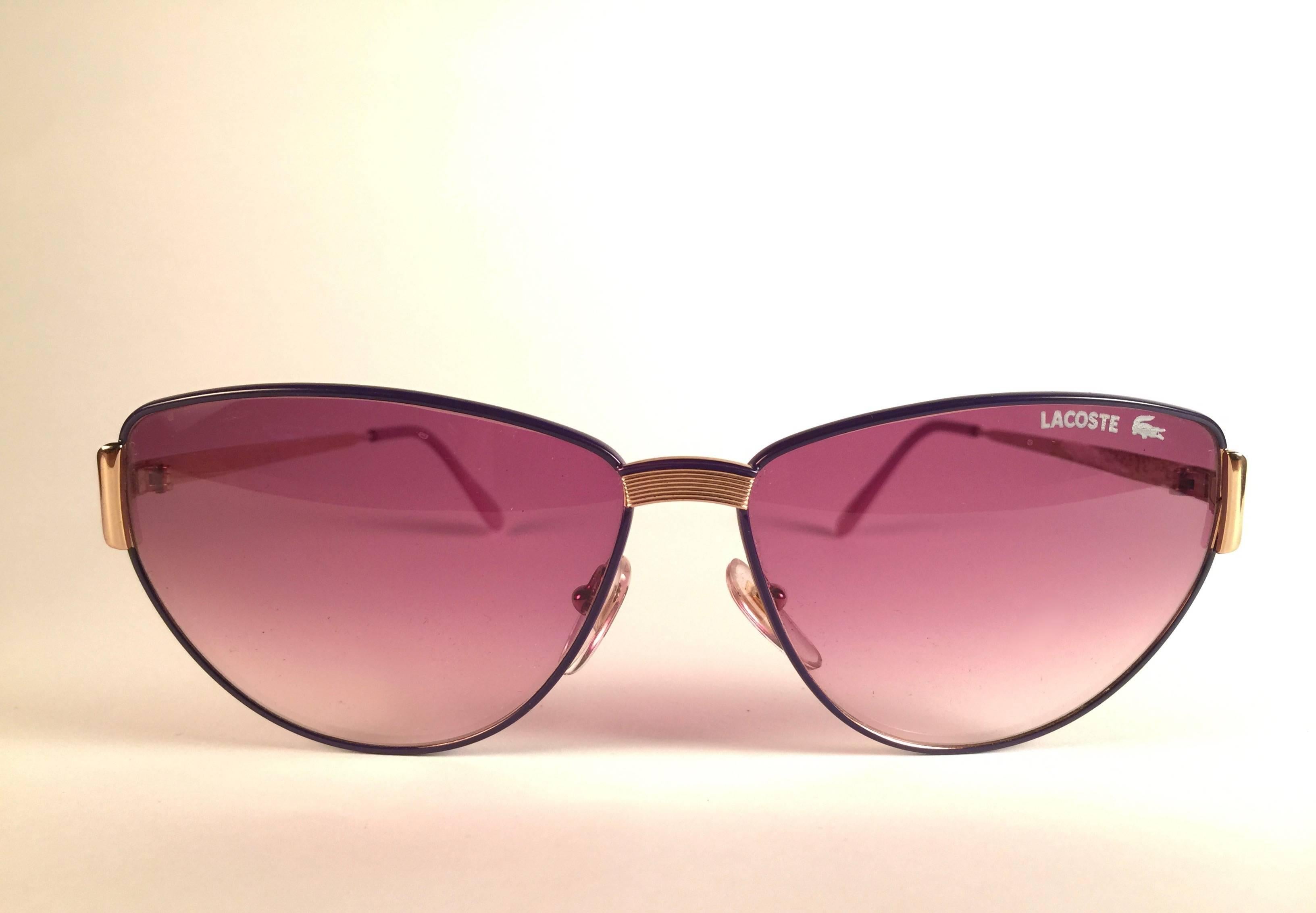 New Vintage Lacoste Purple frame holding a pair of rose gradient lenses. 

This pair may have minor sign of wear on the lens due to storage.

New, never worn or displayed.

Design and produced in France.

