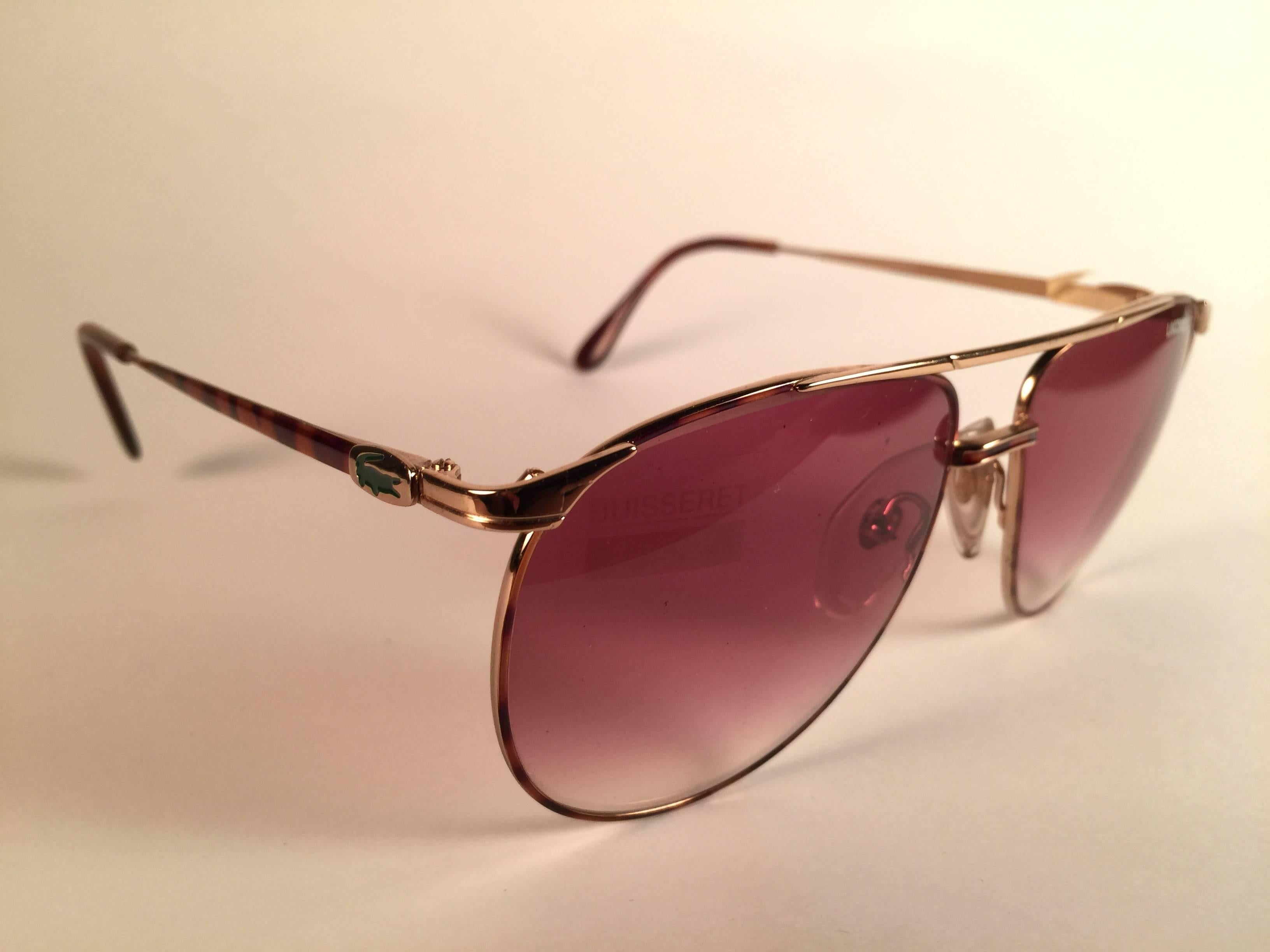 New Vintage Lacoste Tortoise and gold frame holding a pair of rose gradient lenses.   

This pair may have minor sign of wear on the lens due to storage.  

New, never worn or displayed.  

Design and produced in France.