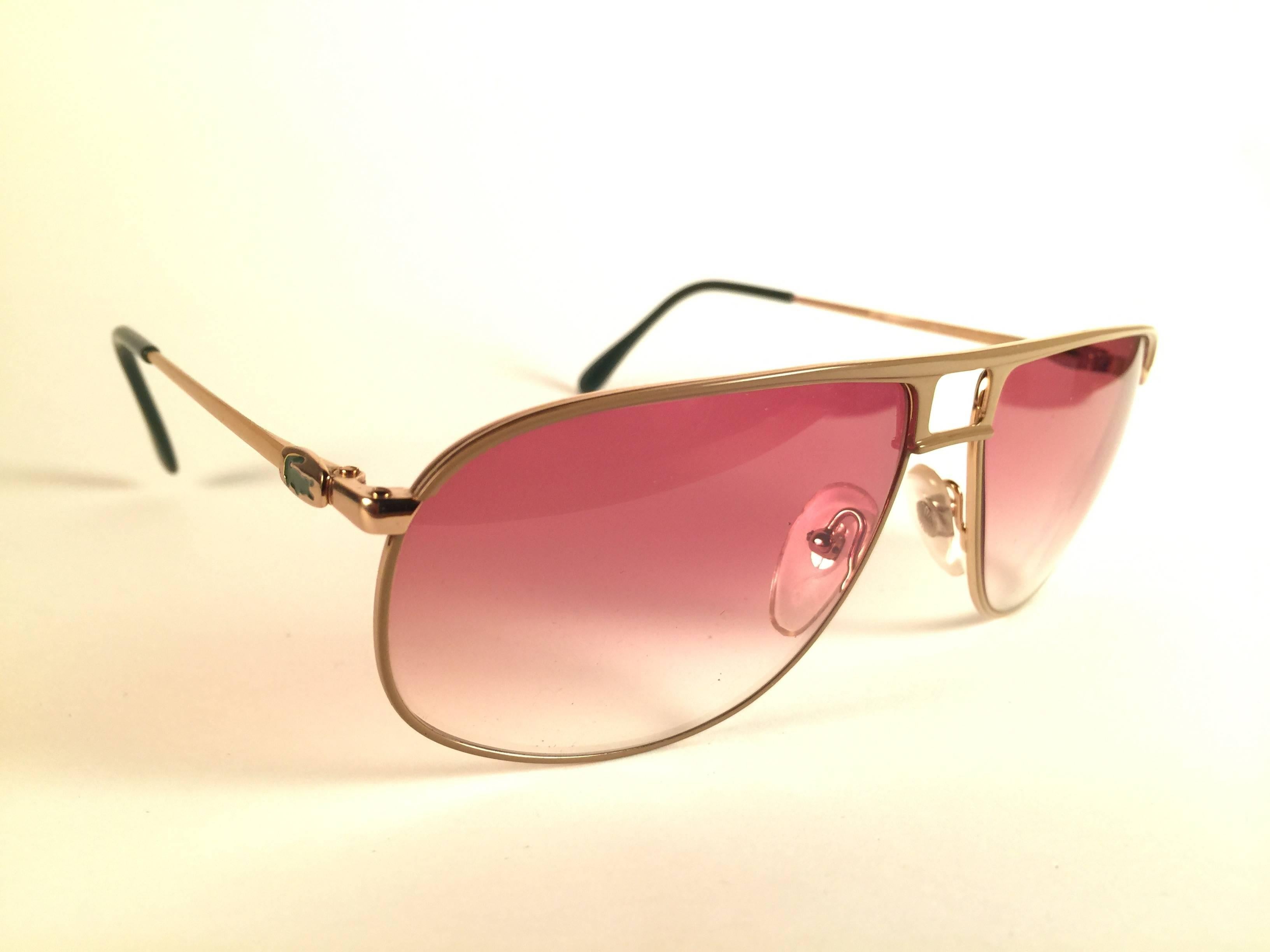 New Vintage Lacoste Gold frame holding a pair of rose gradient lenses.   
This pair may have minor sign of wear on the lens due to storage.  
New, never worn or displayed.  
Design and produced in France.