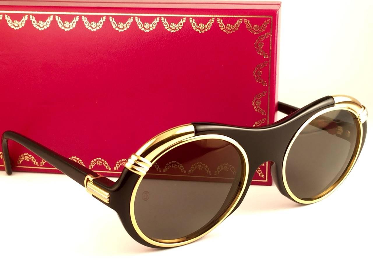 New from 1991 Original Cartier Diabolo Art Deco Sunglasses with spotless amazing brown gold mirrored (uv protection). 
Frame has the famous real gold and white gold accents in the middle and on the sides.
All hallmarks. Cartier gold signs on the