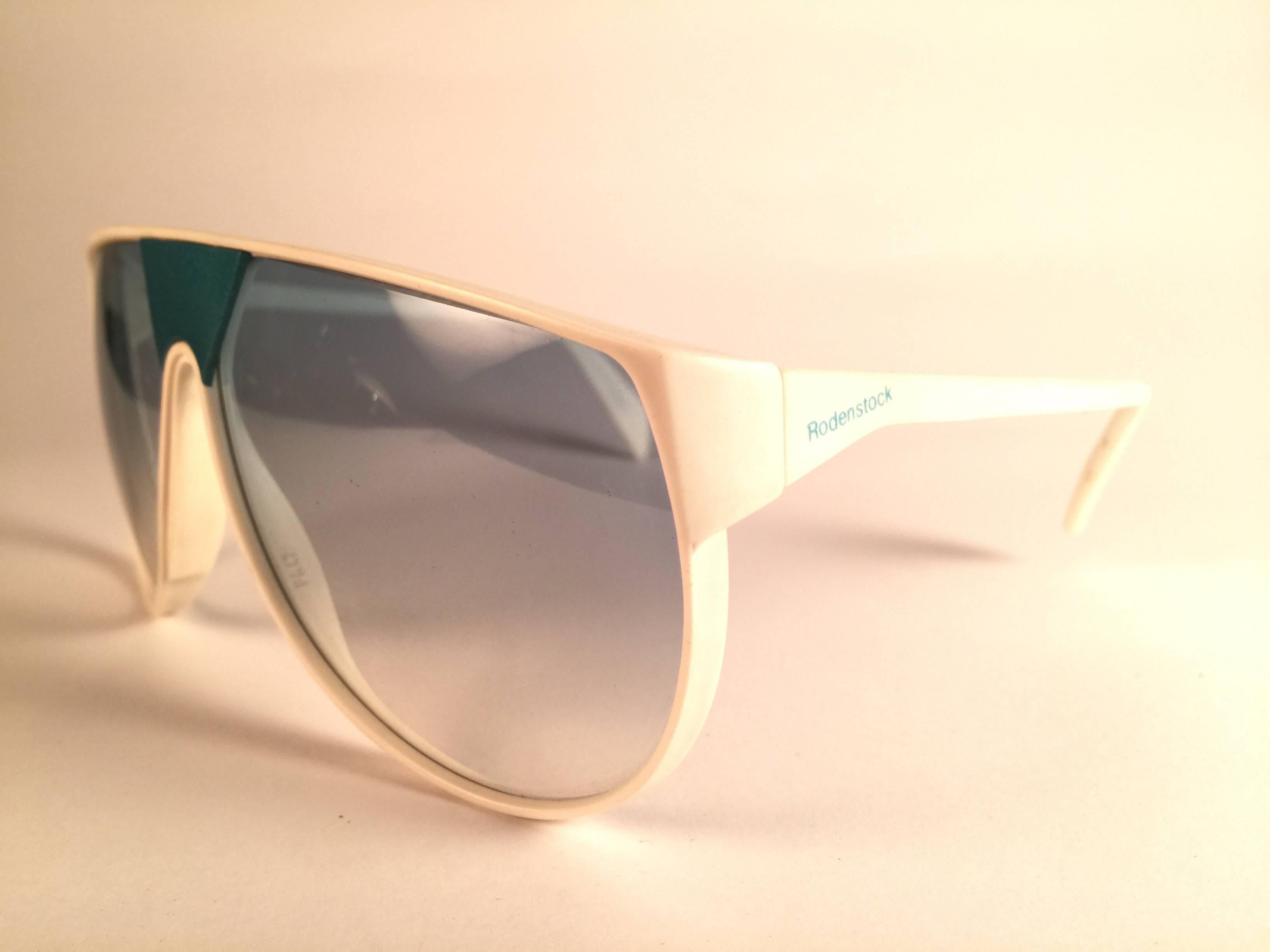 New Vintage Rodenstock sunglasses.  

White frame with turquoise accents sporting a pair of grey gradient lenses.  Never worn or displayed. 
This item may show minor sign of wear due to nearly 40 years of storage.  Designed and produced in Germany.