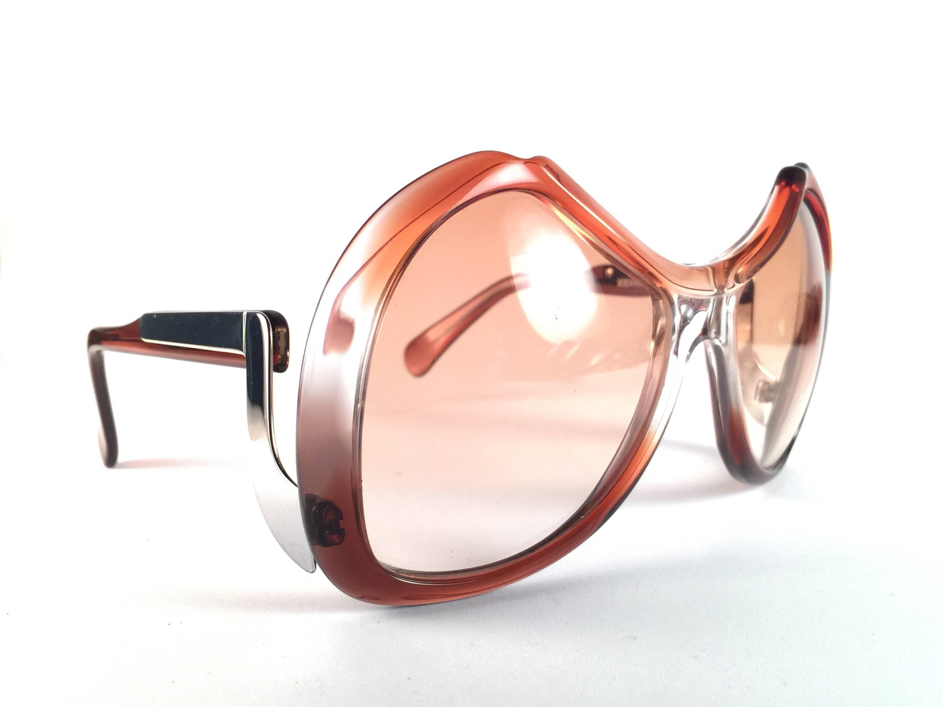 New Vintage Collector Item Menrad Clear Amber and Silver Sunglasses frame holding a spotless pair of light gradient lenses.  

Made in Germany in 1970's.