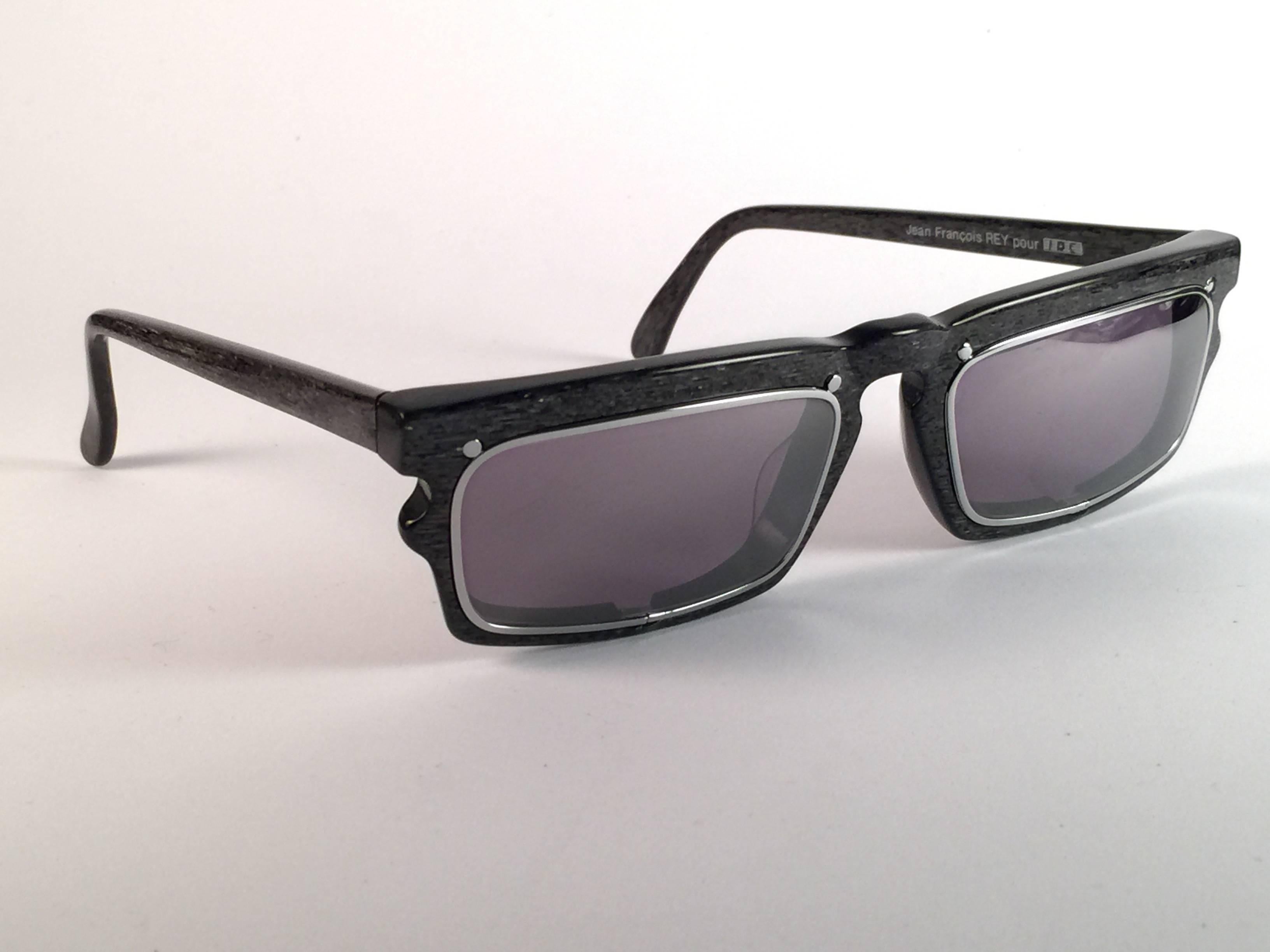 New vintage IDC 767, rectangular Black marbled frame holding pair of spotless grey lenses. The very same model worn by Anthony Kiedis from Red Hot Chili Peppers. New, never worn or displayed this pair may have minor sign of wear due to storage. Made