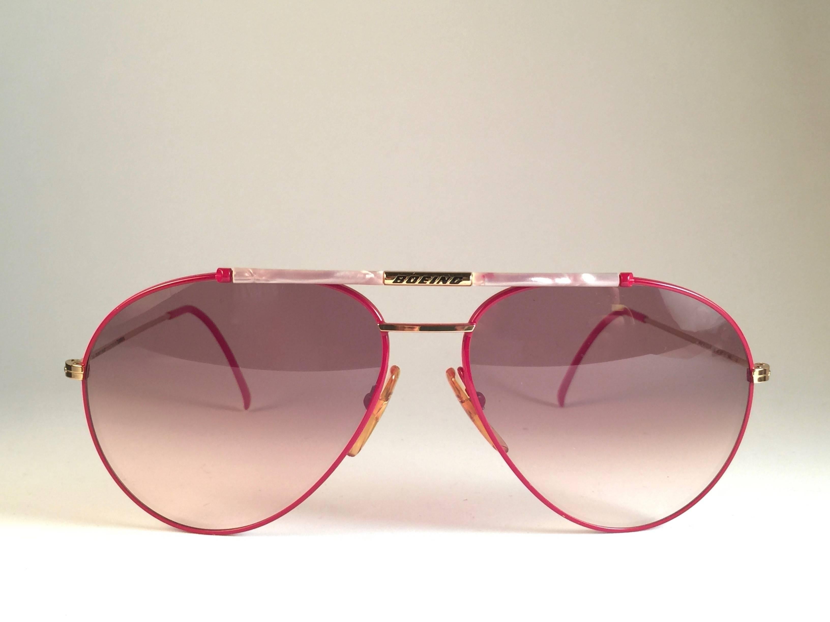 New 1980's Boeing by Carrera aviator gold and red frame with rose lenses.   Amazing craftsmanship and quality.   

Comes with the original black Carrera hard case thats has some wear on it due to nearly 40 years of storage. 

New, never worn. Made