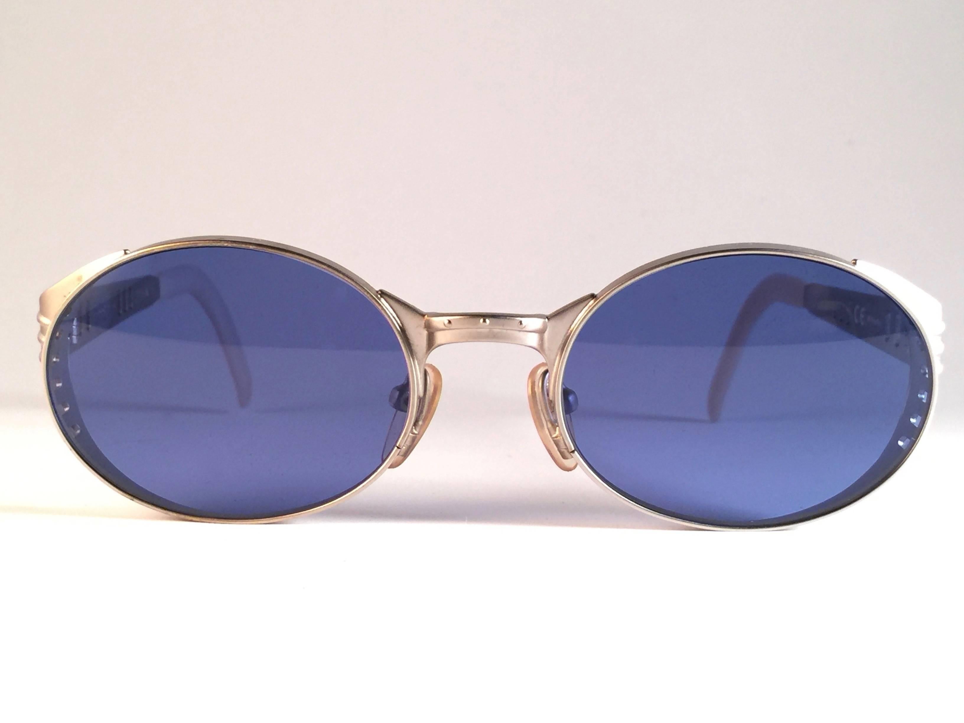 New Vintage Rare Gaultier Round Aluminium frame.  

Rare item in new and unworn condition. 
Spotless light blue lenses.  Please consider that this item is nearly 40 years old so it could show minor sign of wear due to storage.  

 Made in France.
