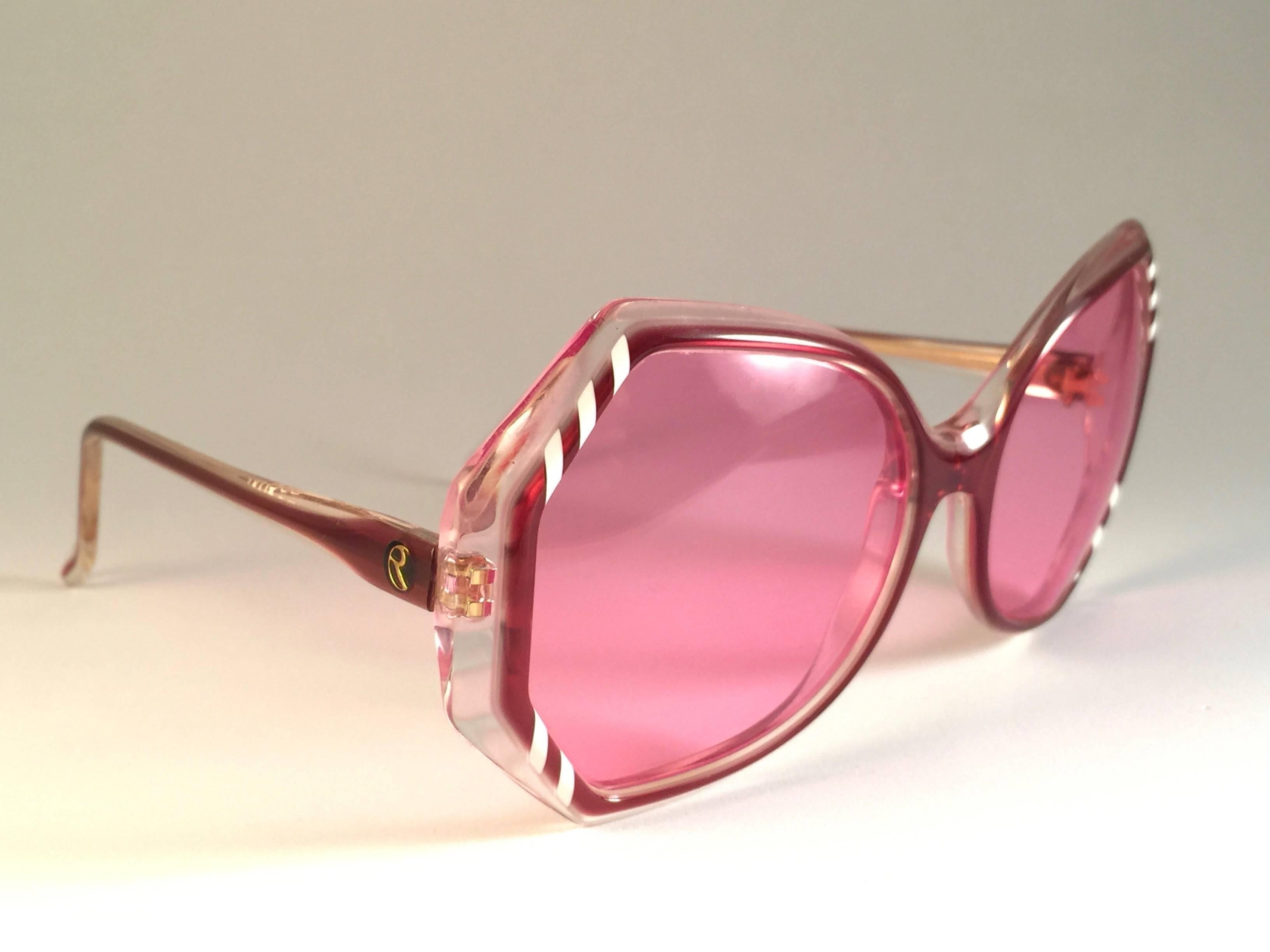 New Vintage Rochas clear and red sunglasses sporting spotless candy pink lenses.

Please notice this item its nearly 40 years old and may show sign of wear due to storage.

Made in France.