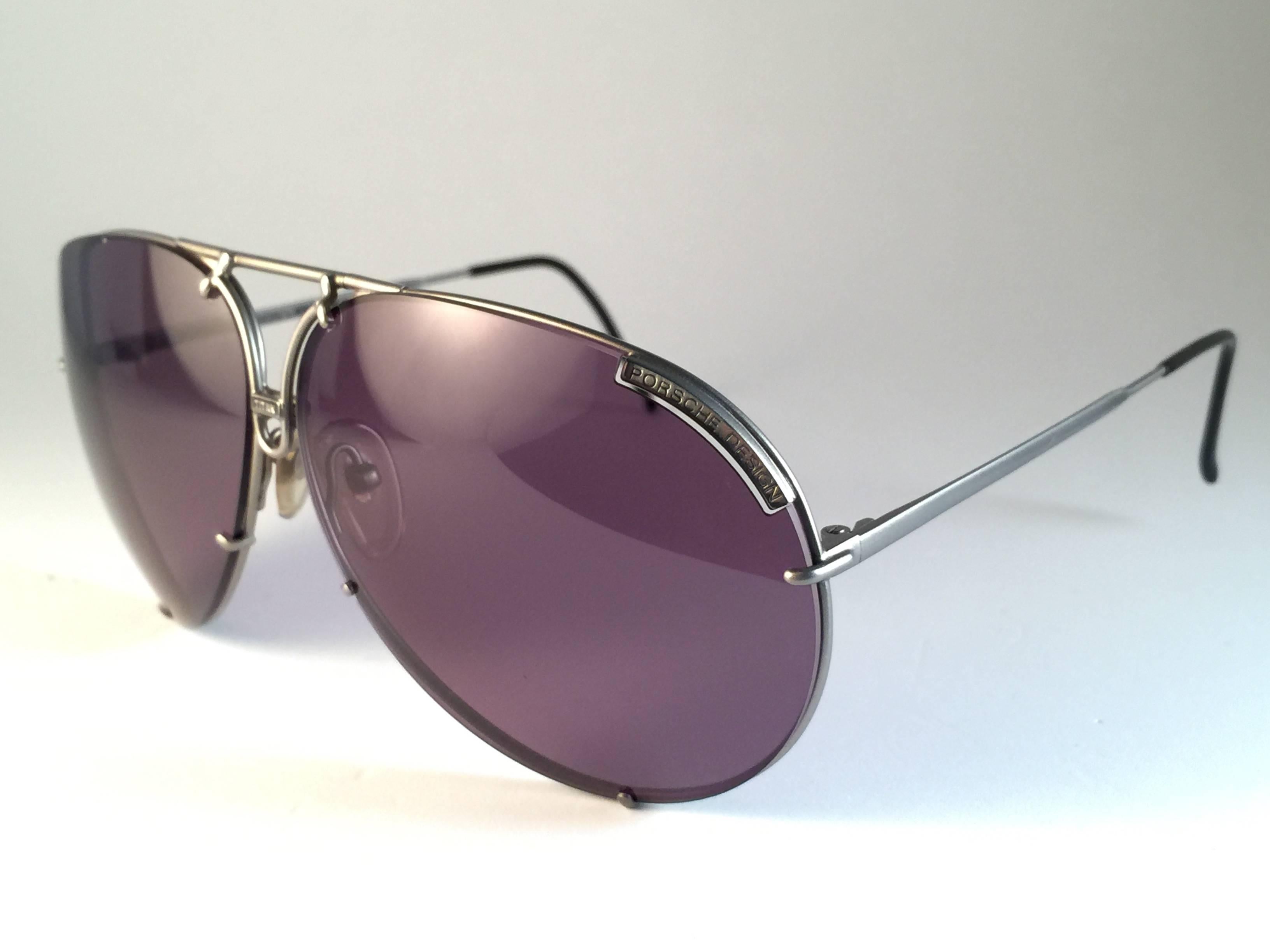 New 1980's Porsche Design 5621 Silver Matte Titan frame with grey lenses.  Amazing craftsmanship and quality.  
Comes with the original black Porsche hard case thats has some wear on it due to nearly 40 years of storage. Extra set of lenses for this