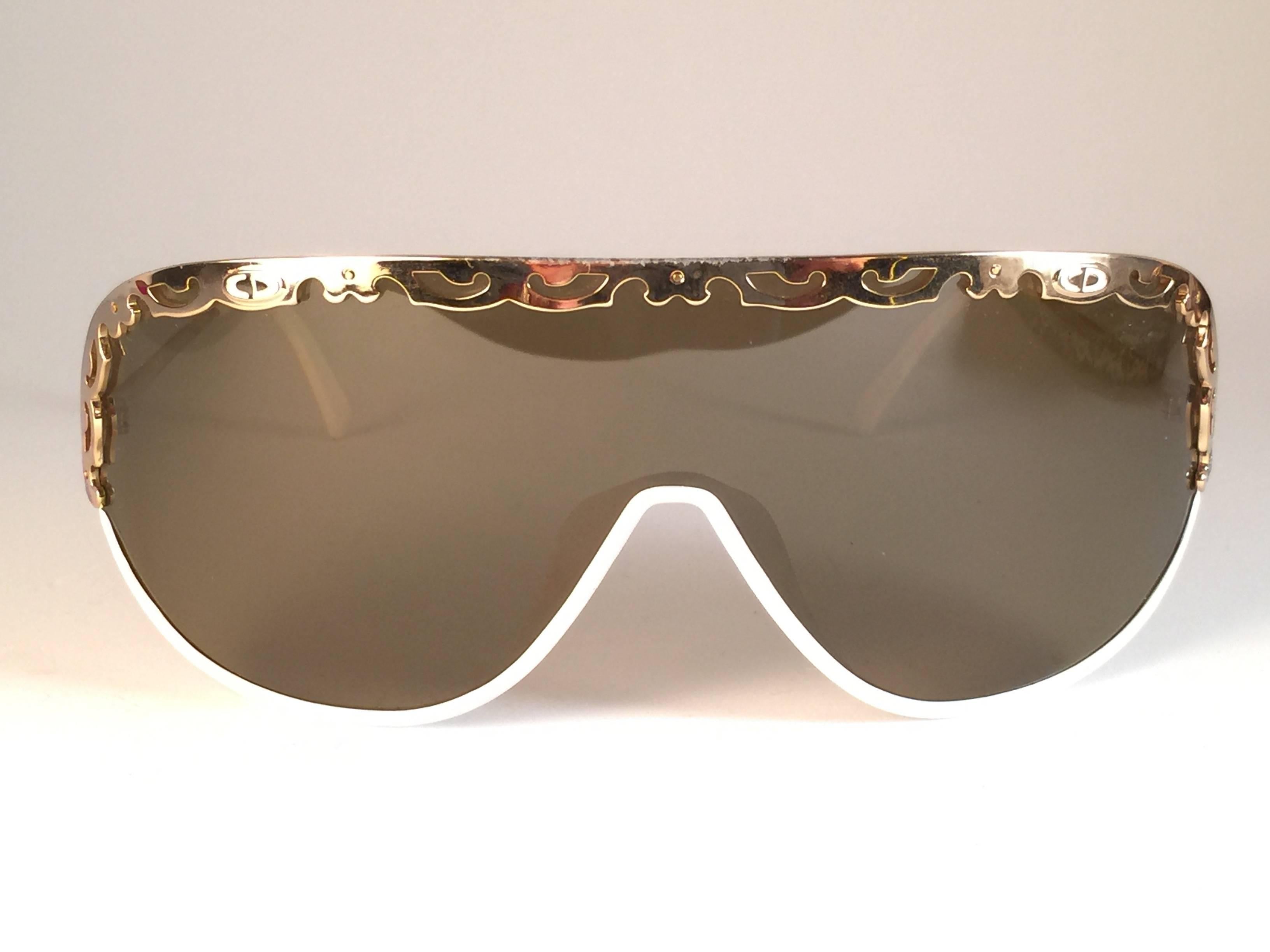 New Vintage Christian Dior 2501 white mask sunglasses wrap around style with solid brown lenses 1980’s. 
This item may show light sign of wear due to storage.  Made by Optyl. Manufactured in Austria